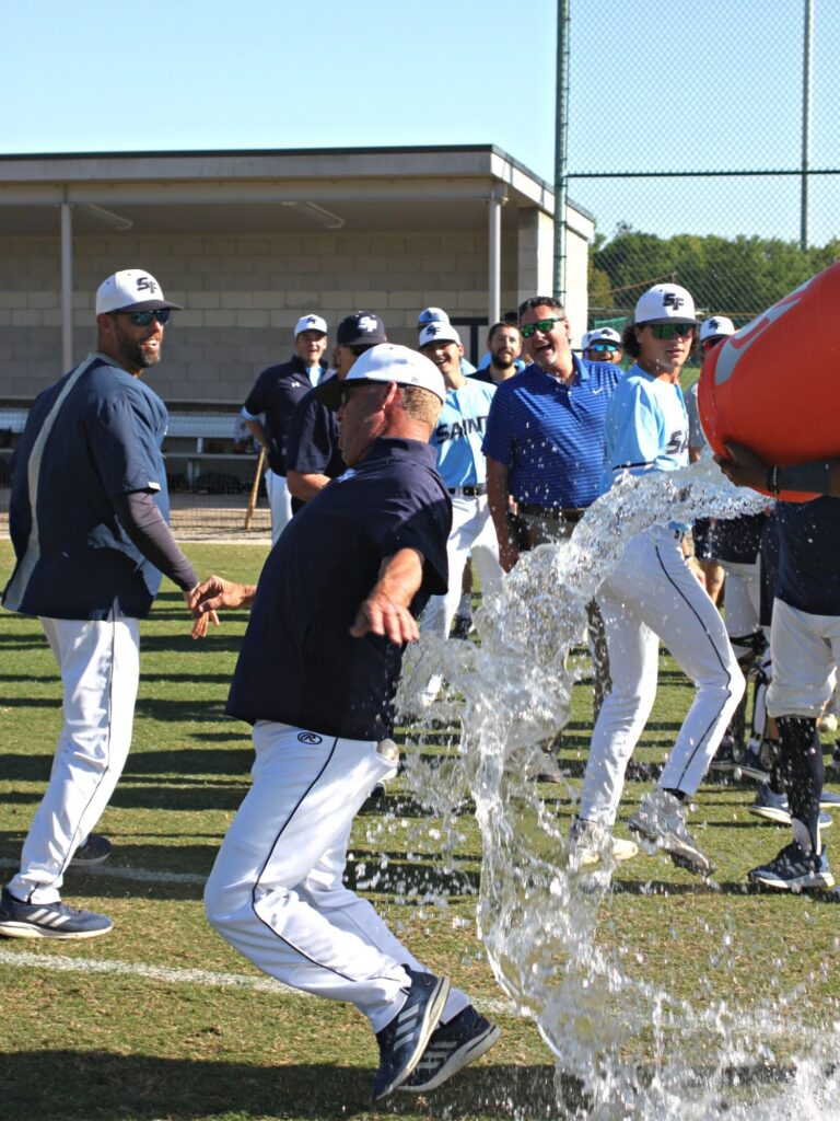 Santa  Fe College baseball coach Johnny Wiggs nearly doused by his players. 