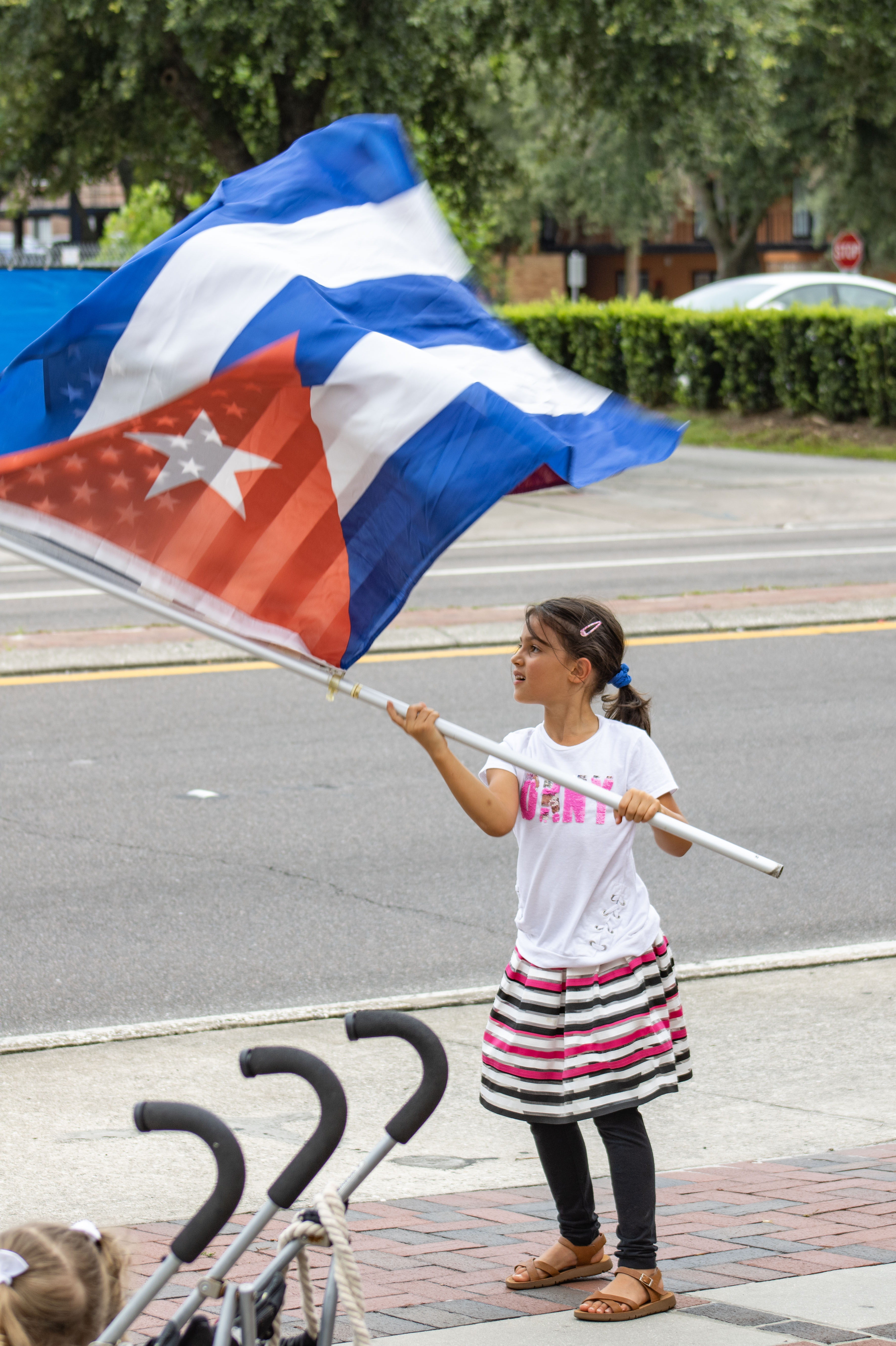 Girl waves Cuban flag at Gainesville rally