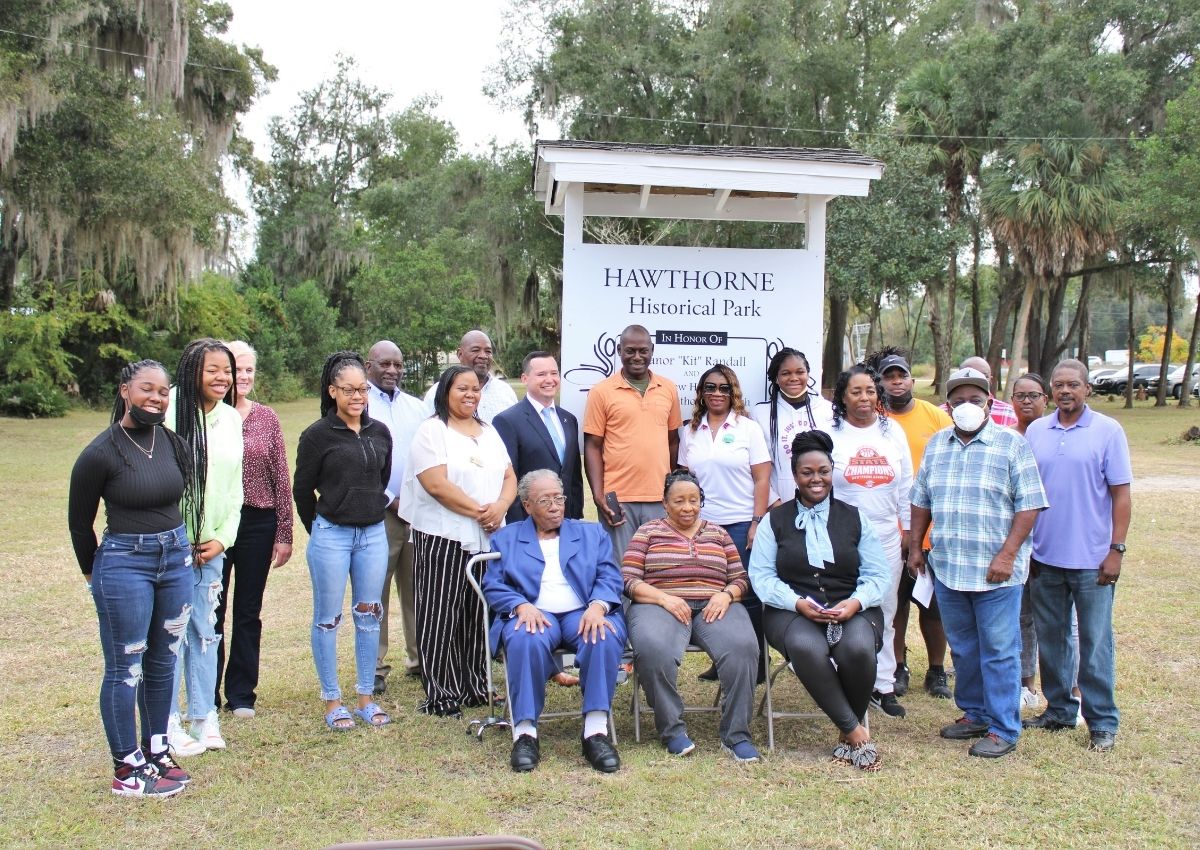Eleanor Randall's family and city staff around the new sign