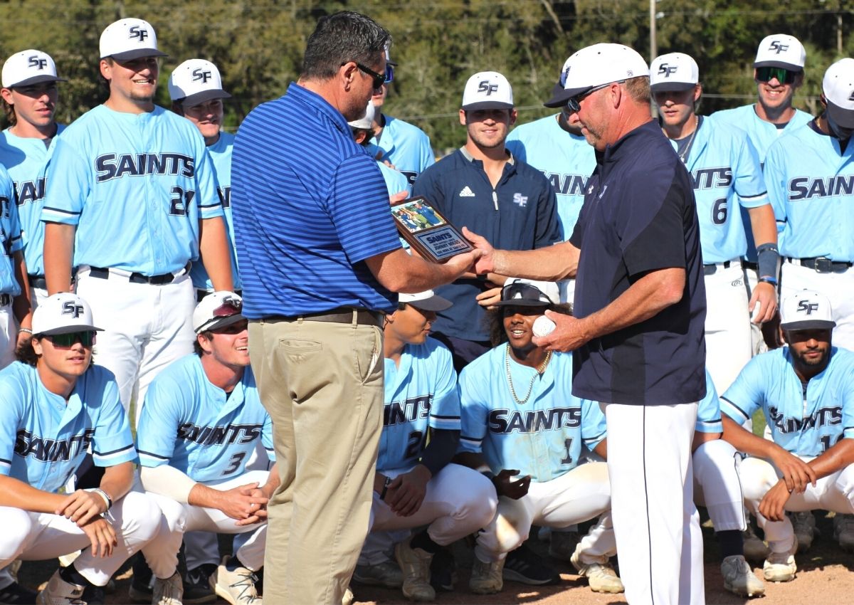Santa Fe College AD Greg McVey presents plaque to baseball coach Johnny Wiggs on 500th win