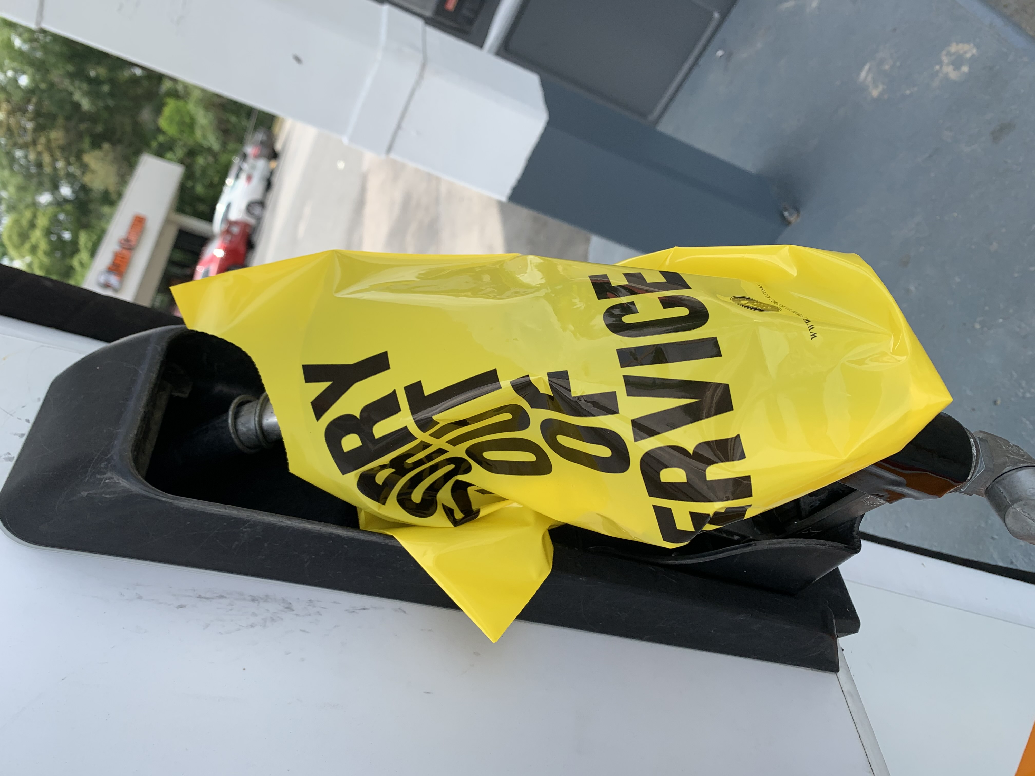 Gas pump handled covered with yellow bag