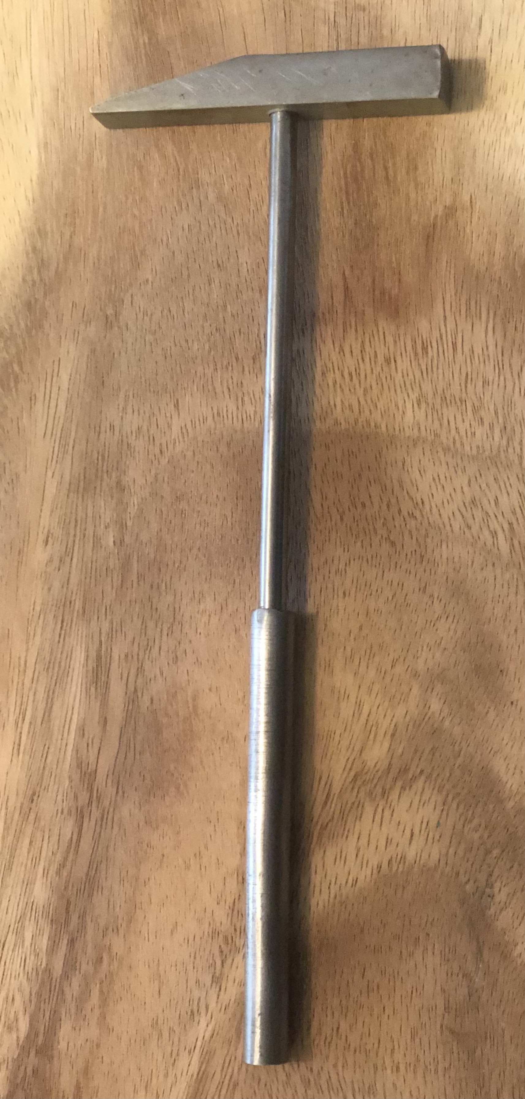 Handmade hammer on wooden surface