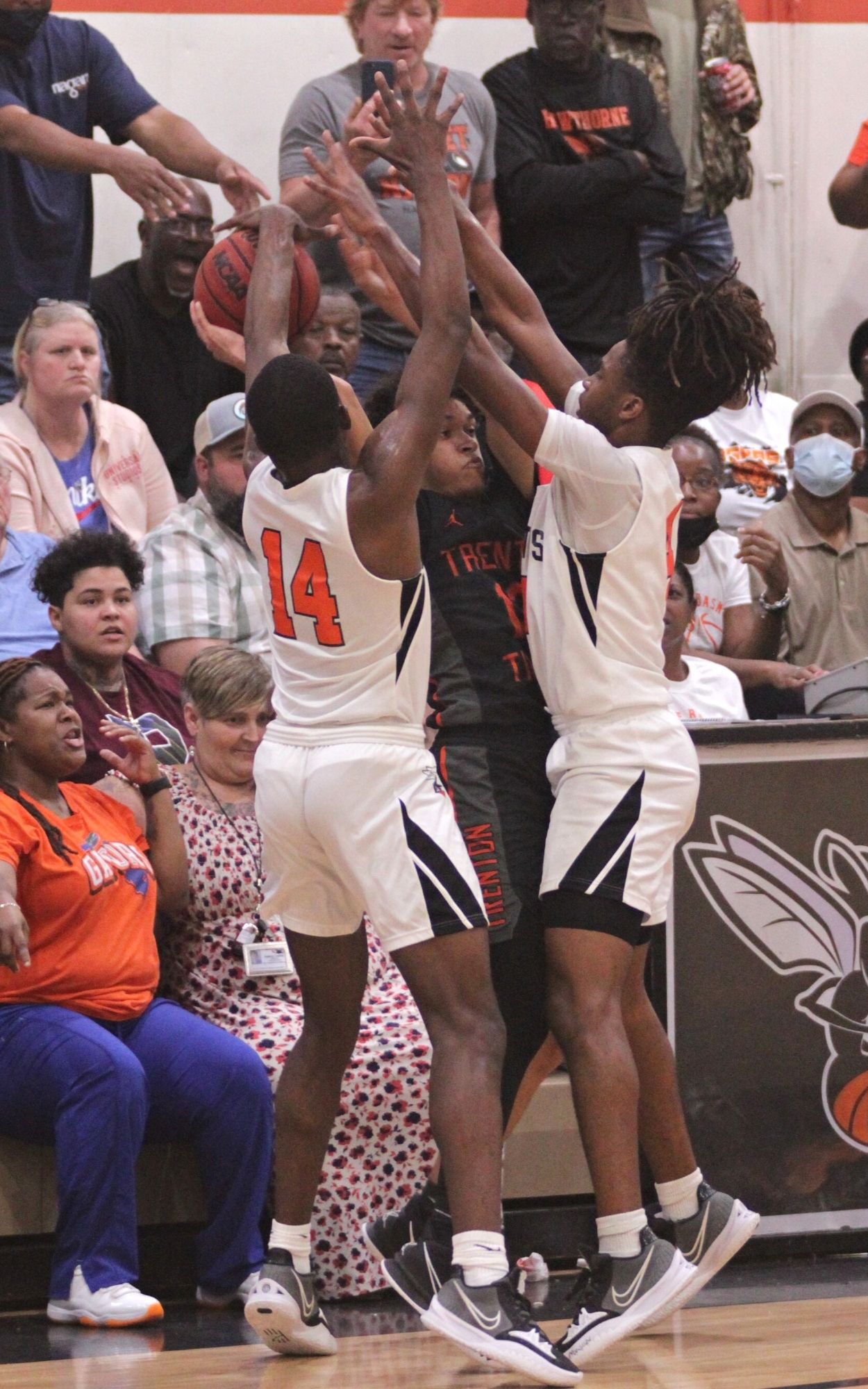 Hawthorne's Jailen Ruth (14) and Jamal Nealy force Trenton's Xavier Jones into a turnover