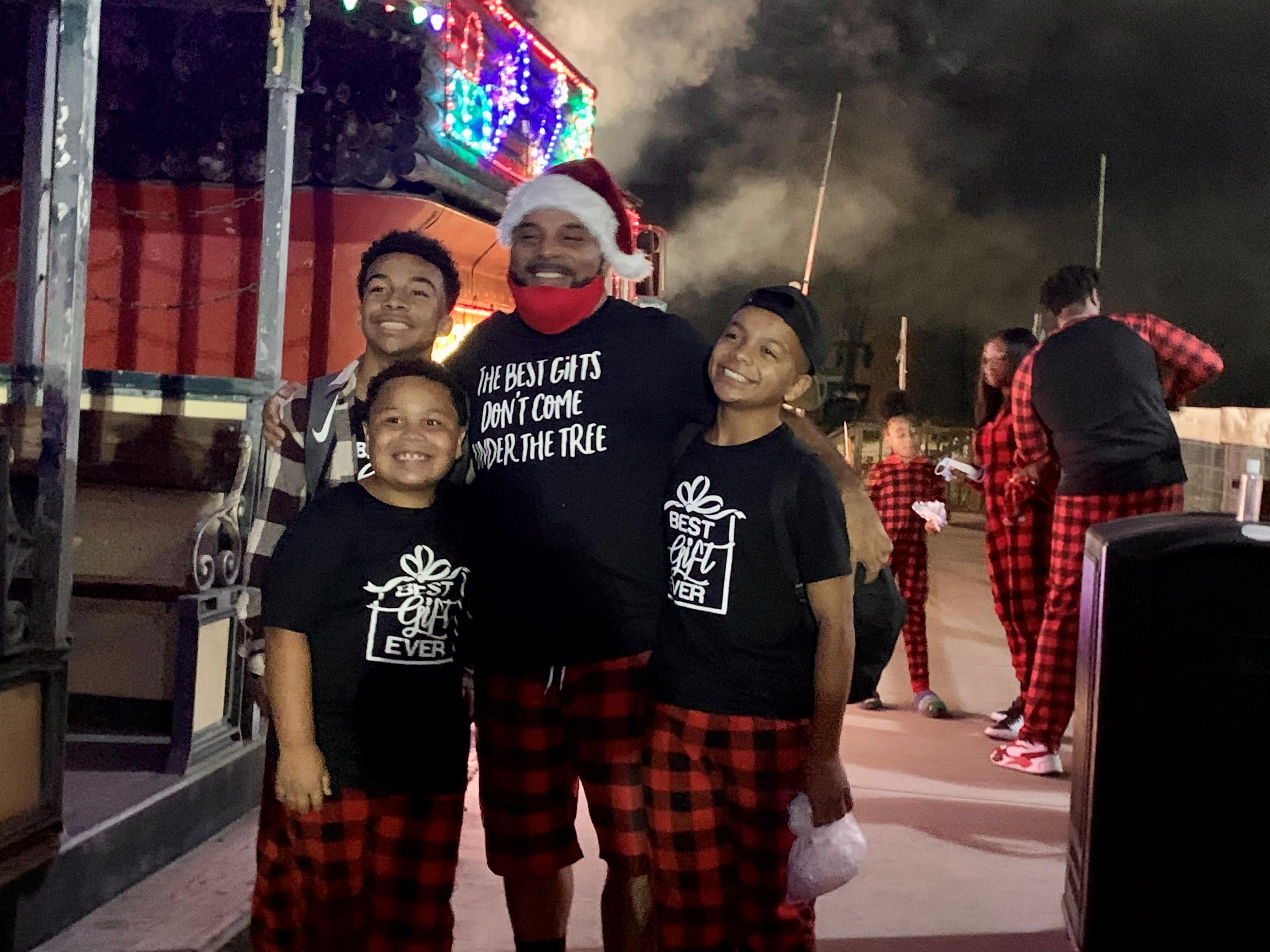 Father and 3 Son posing in Christmas pajamas