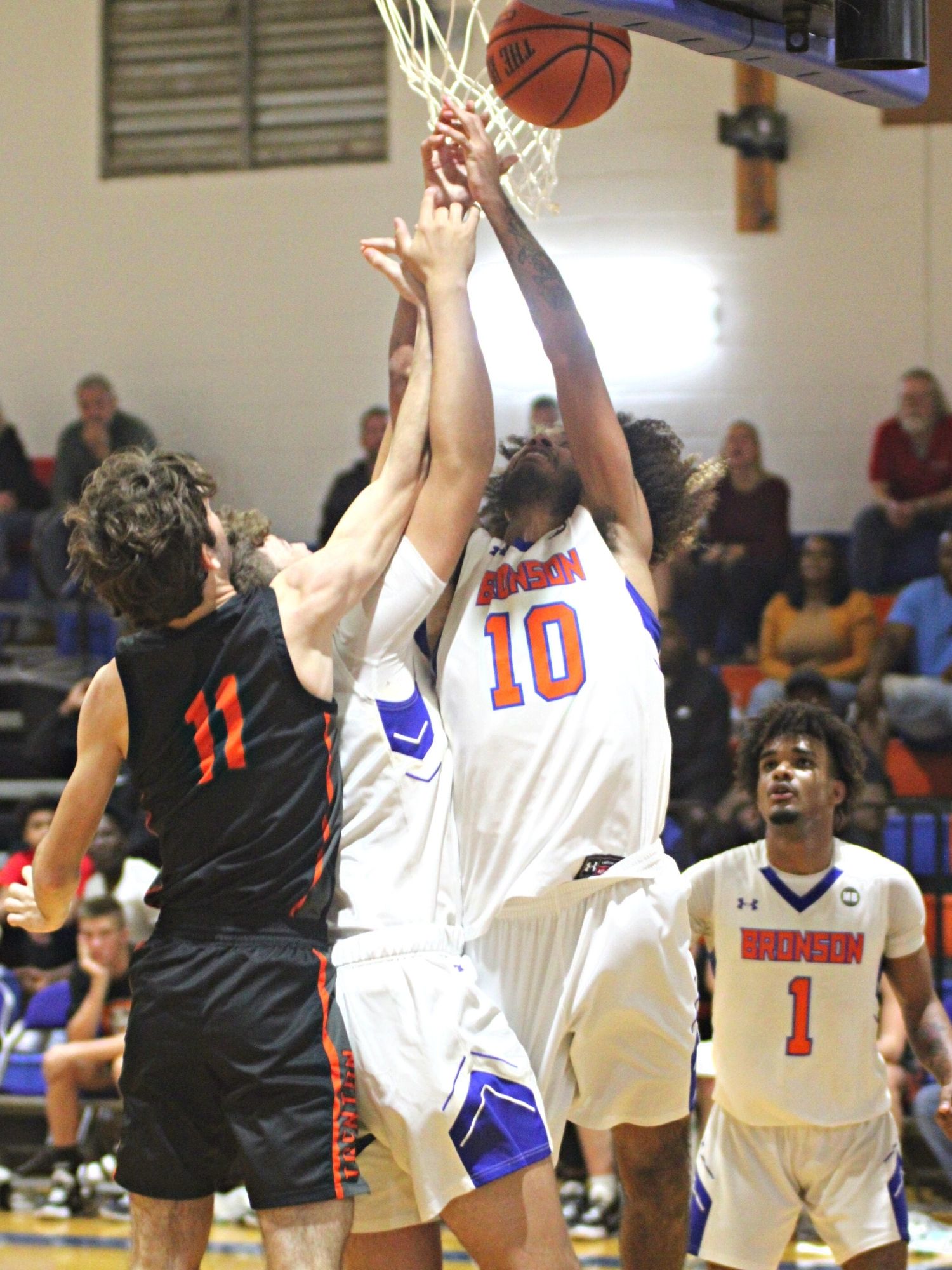 Bronson's Jesse Williams III (10) and Riley Bray battle Trenton's Nathaniel Ridgell (11) for the rebound