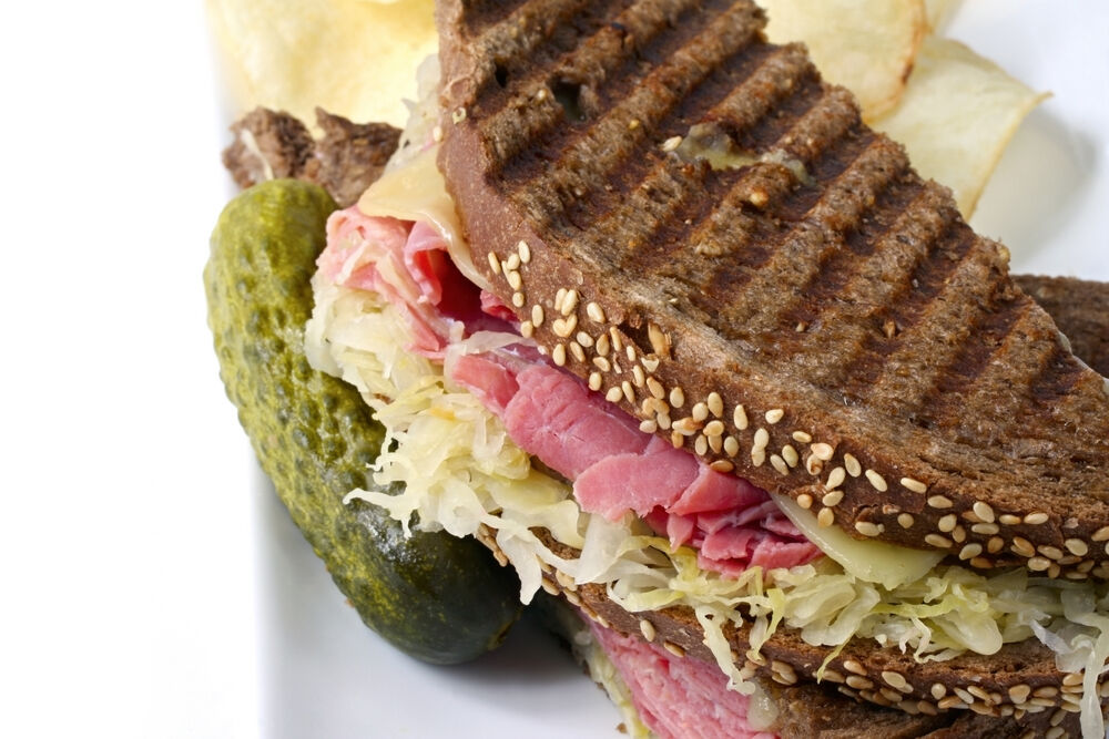 Reuben sandwich on Rye bread with pickle and chips