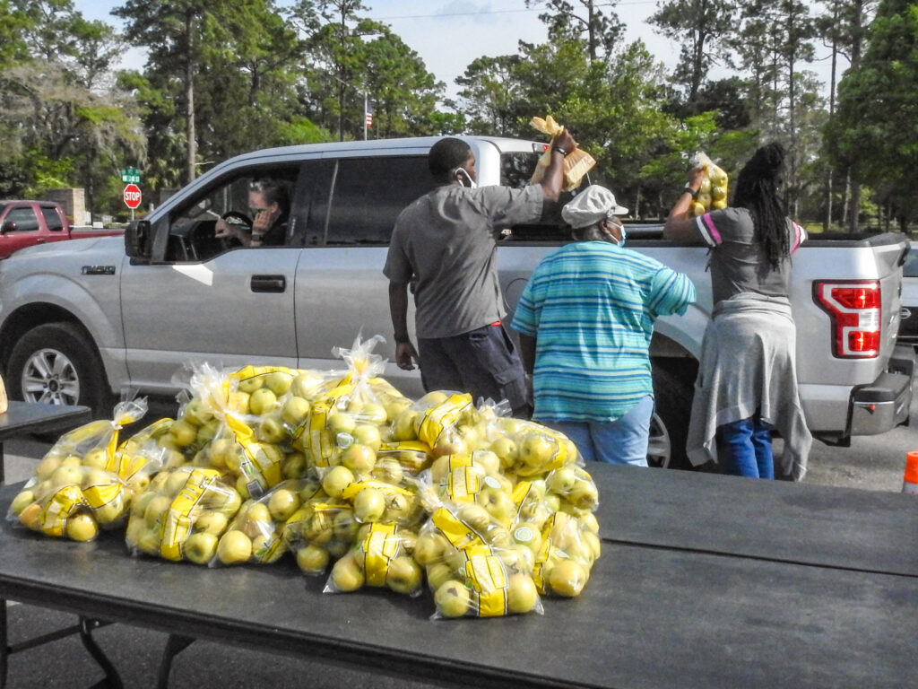 Volunteers serve food at Farm Share event in High Springs