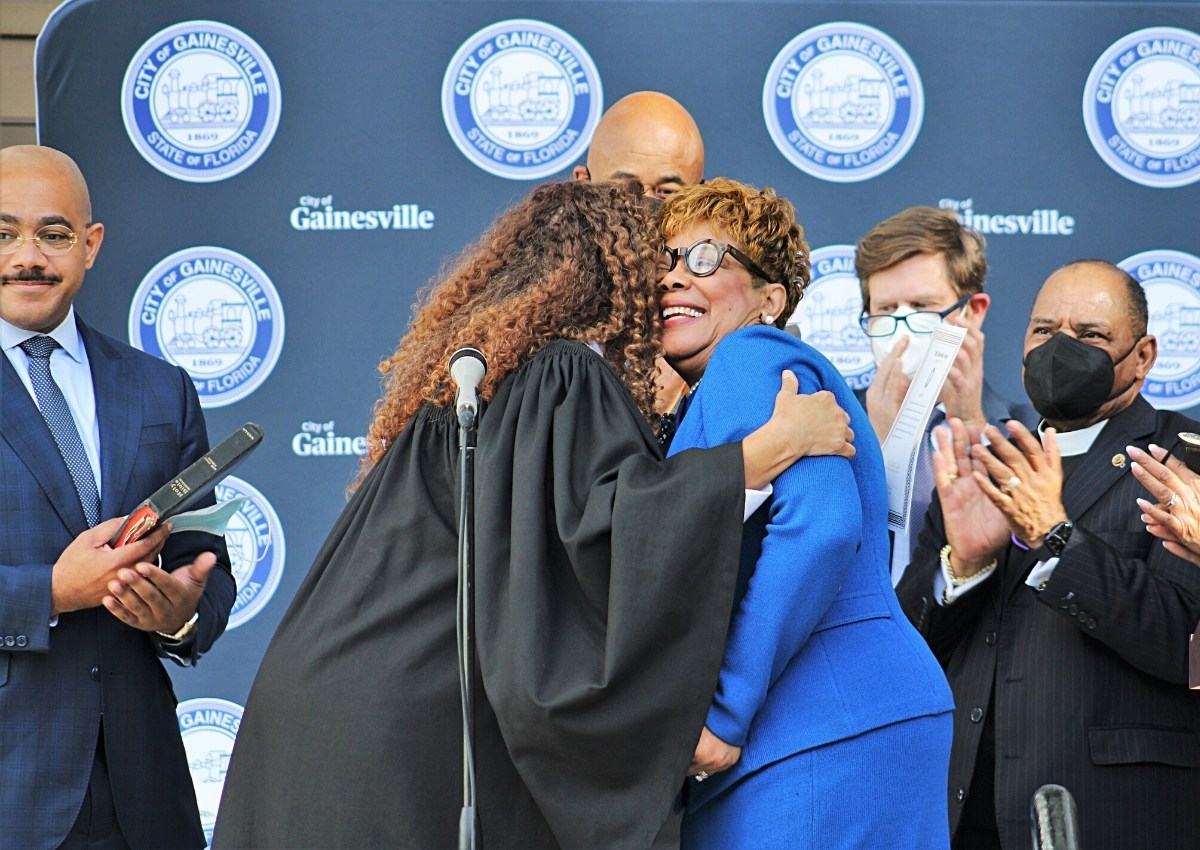 Judge Gloria Walker of Florida's Eighth Judicial Circuit and Commissioner Cynthia Chestnut hug after reciting the oath of office..jpg