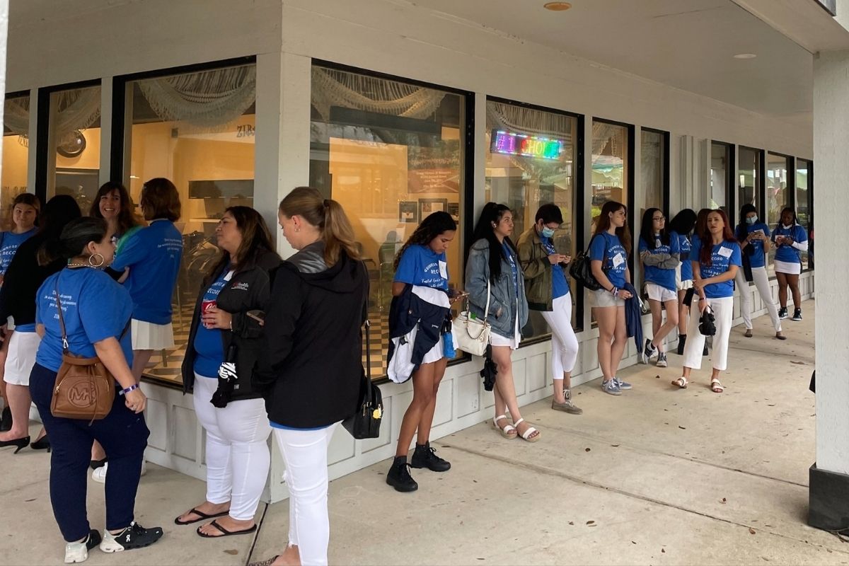 Participants line up to have eyebrows threaded