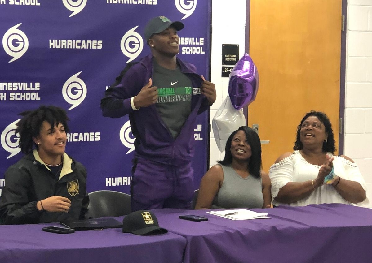 Gainesville High's Dyoni Hill shows his Marshall shirt where he will play college football