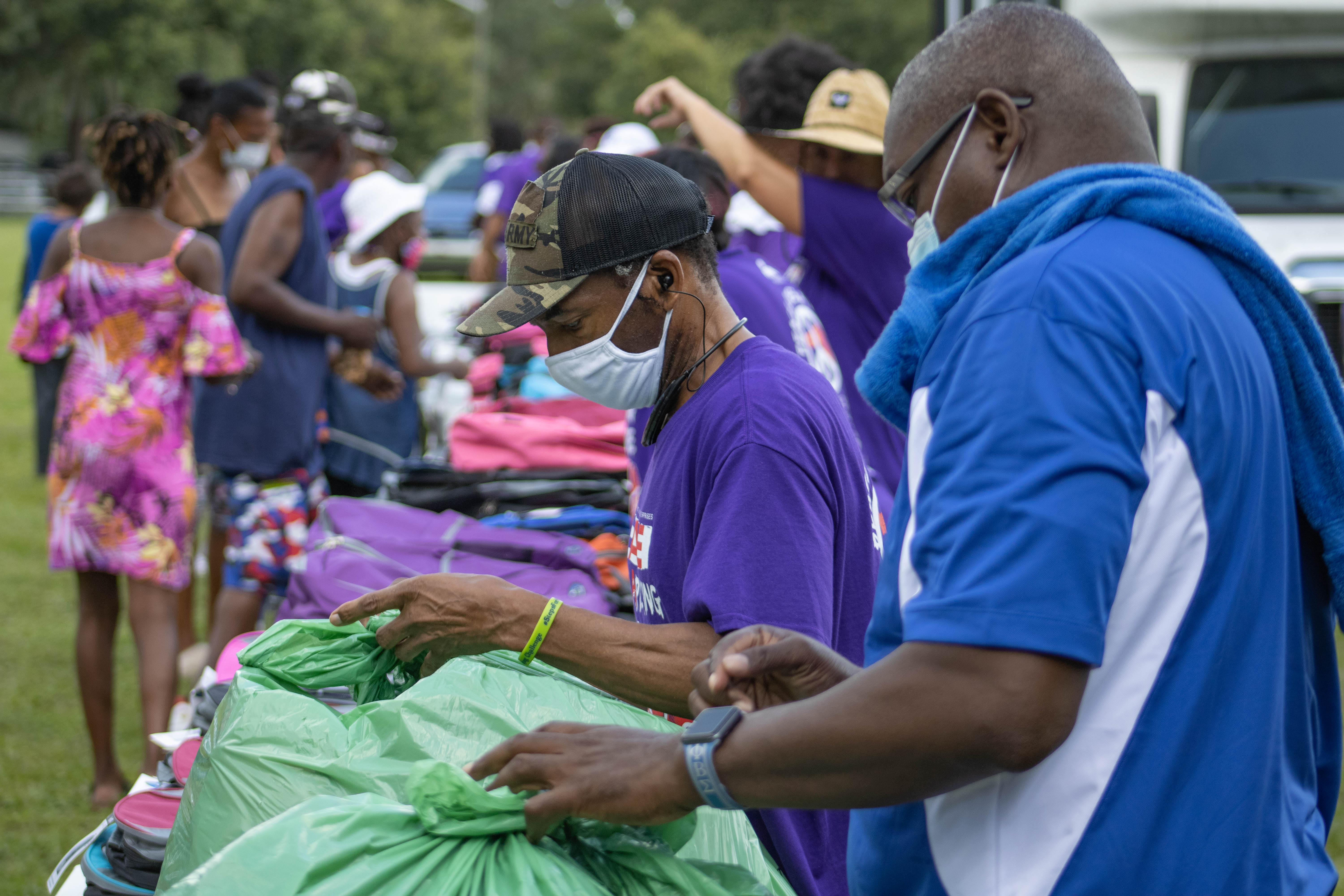 Volunteers load bags at back to school rally