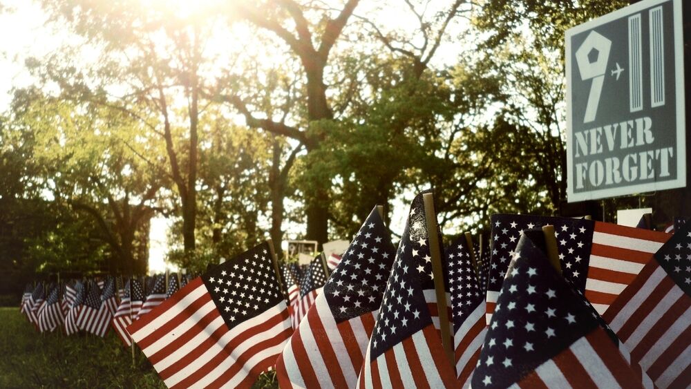 9/11 Never Forget sign with American flags