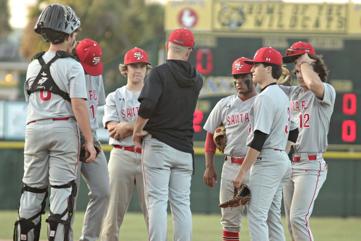 Santa Fe coach Travis Yeckring meets with infield