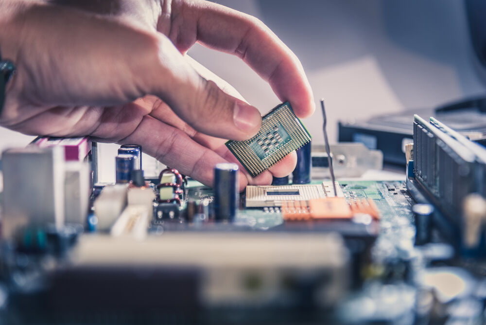 Technician putting CPU on motherboard socket