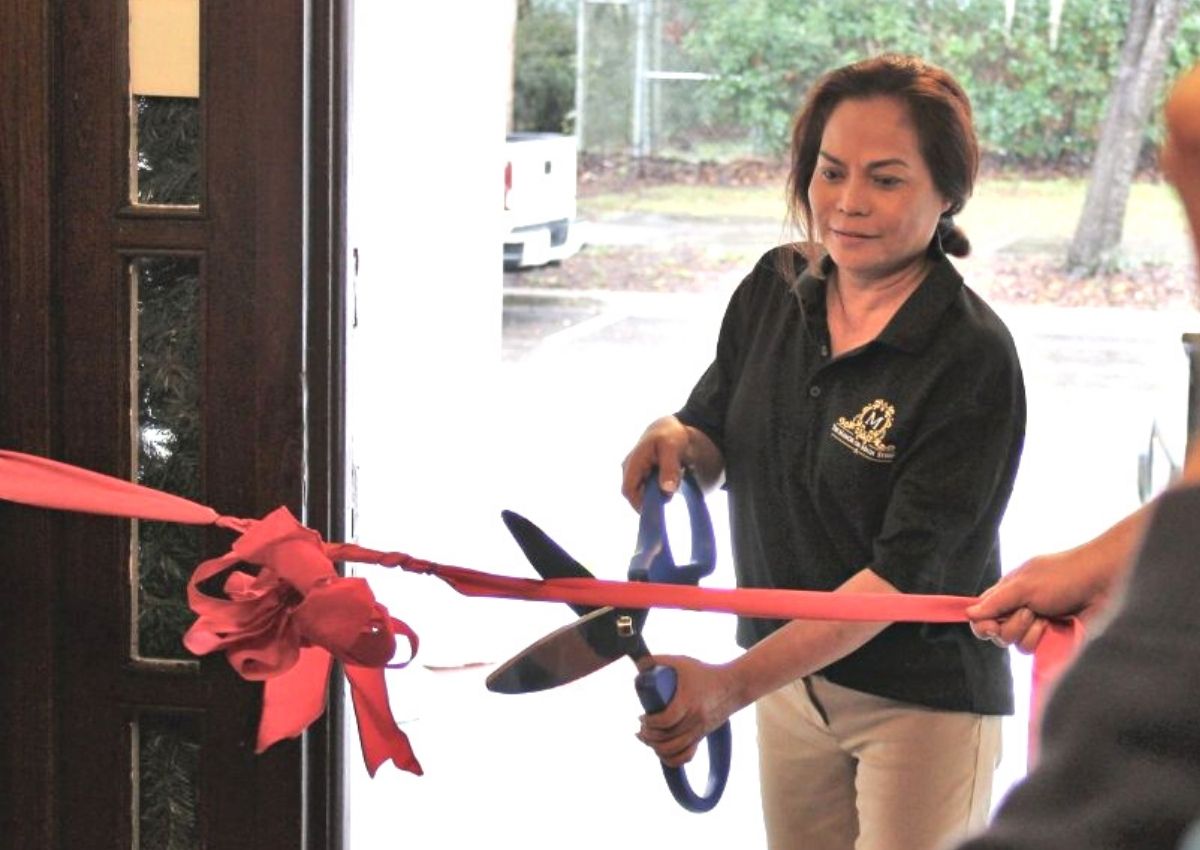 Owner Salvie Andreola cuts the ribbon for the Manor House's Grand Opening