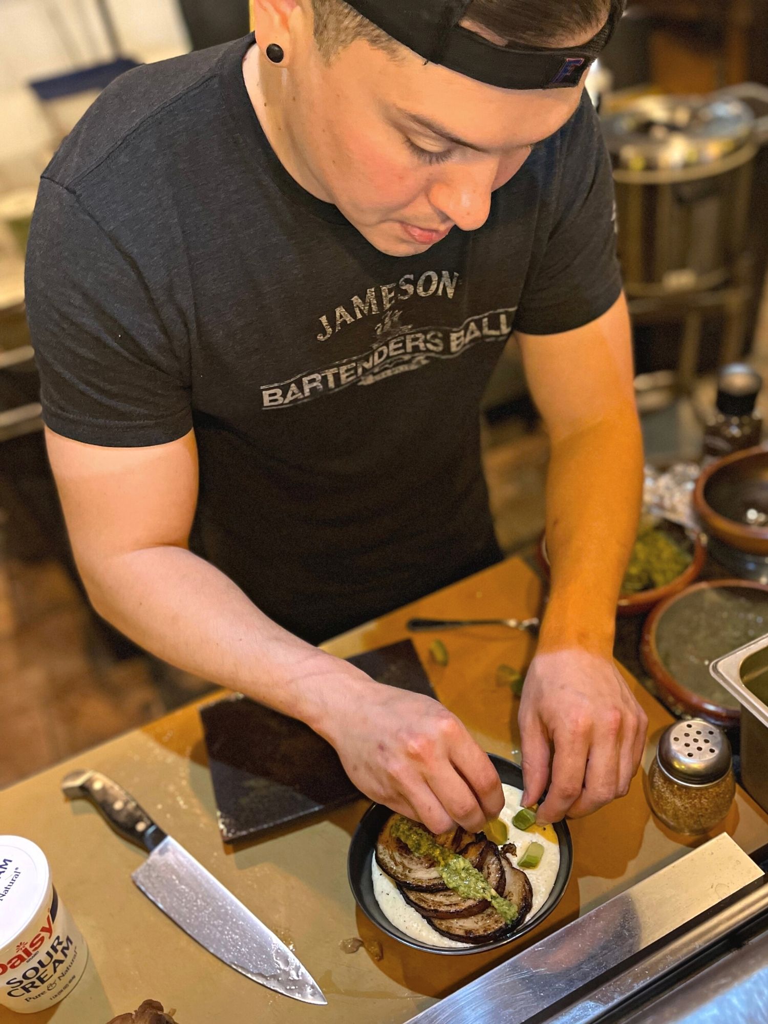 Dylan Sobien prepares food at Pit & Peel