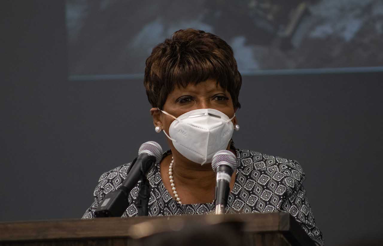 SBAC Chair Leanetta McNealy behind microphones