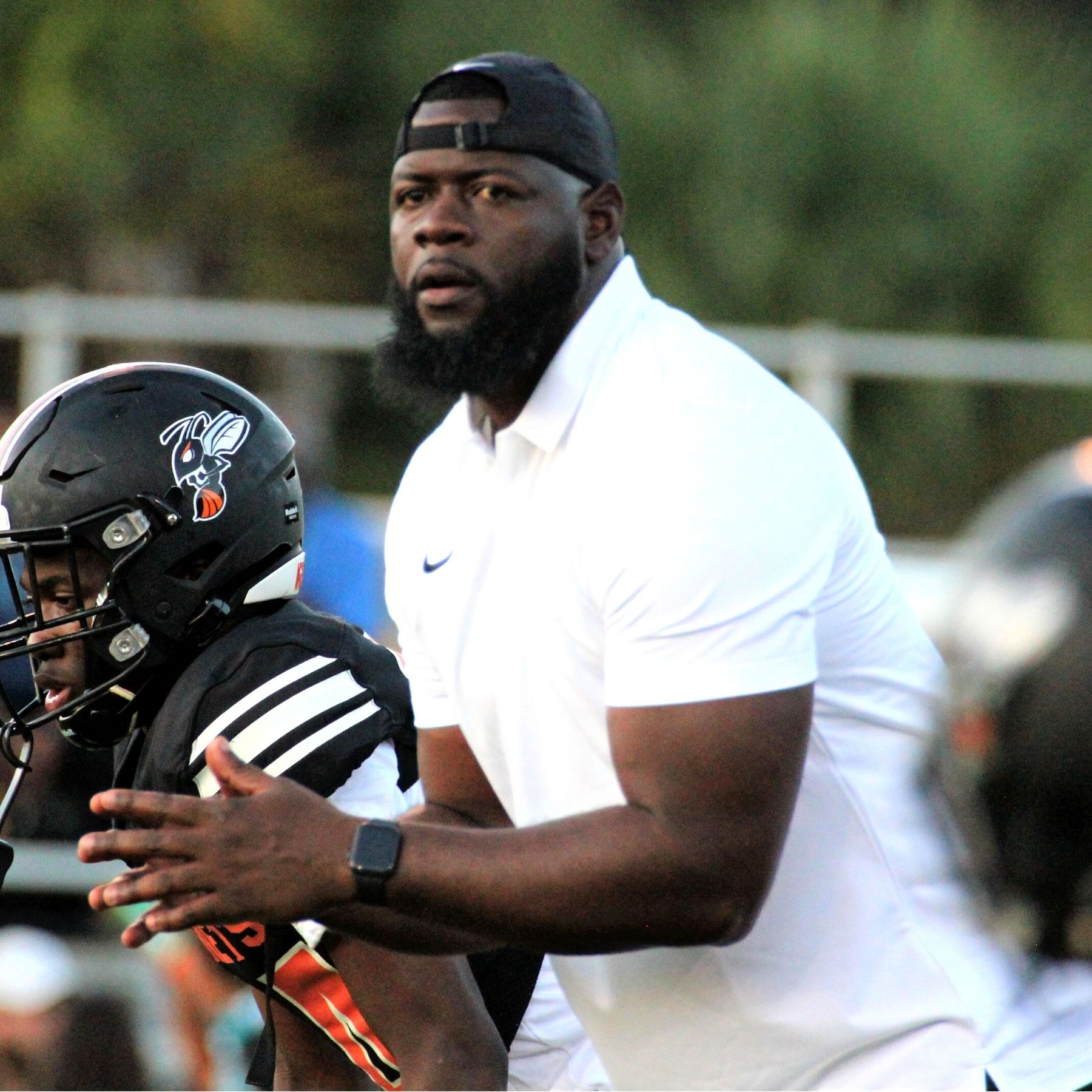 Hawthorne football coach Cornelius Ingram with players
