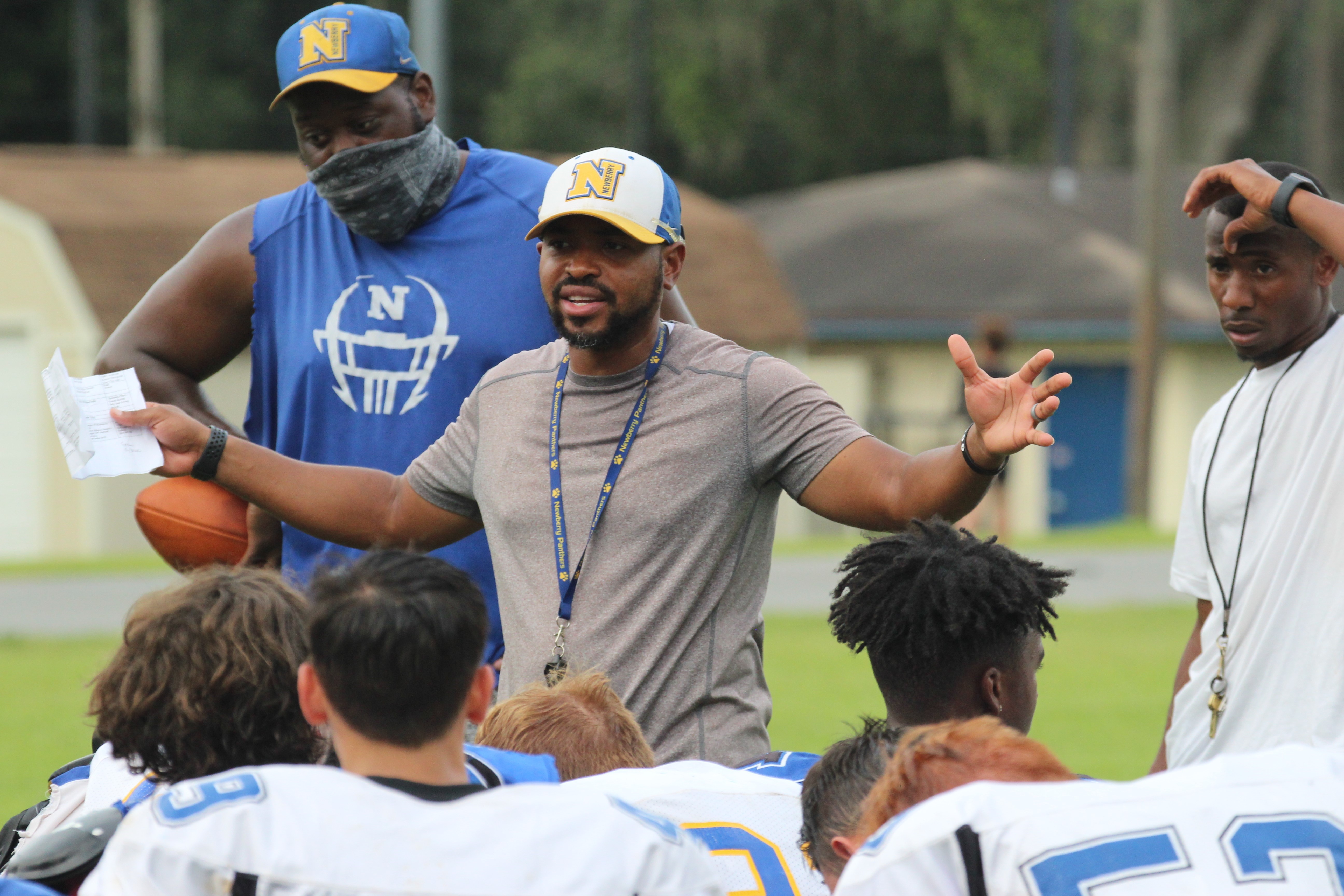 Newberry High football coach Ed Johnson talking to players