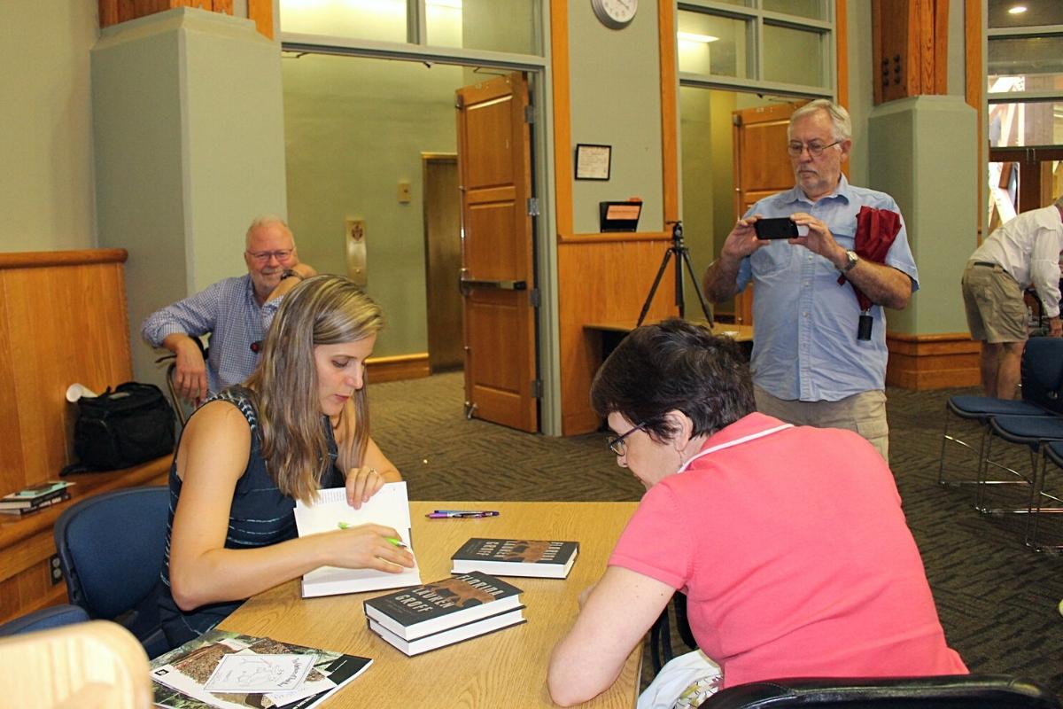 Lauren Groff signs a copy of her novel Florida at the Alachua County Library District