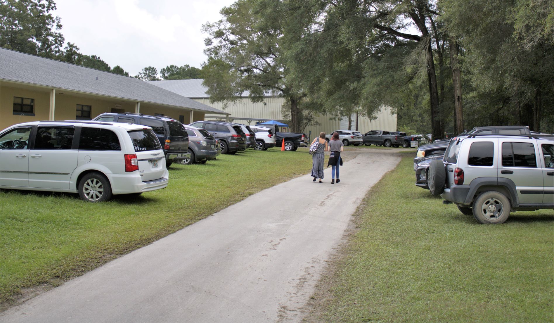 Parking area full of cars at monoclonal antibody treatment site in High Springs