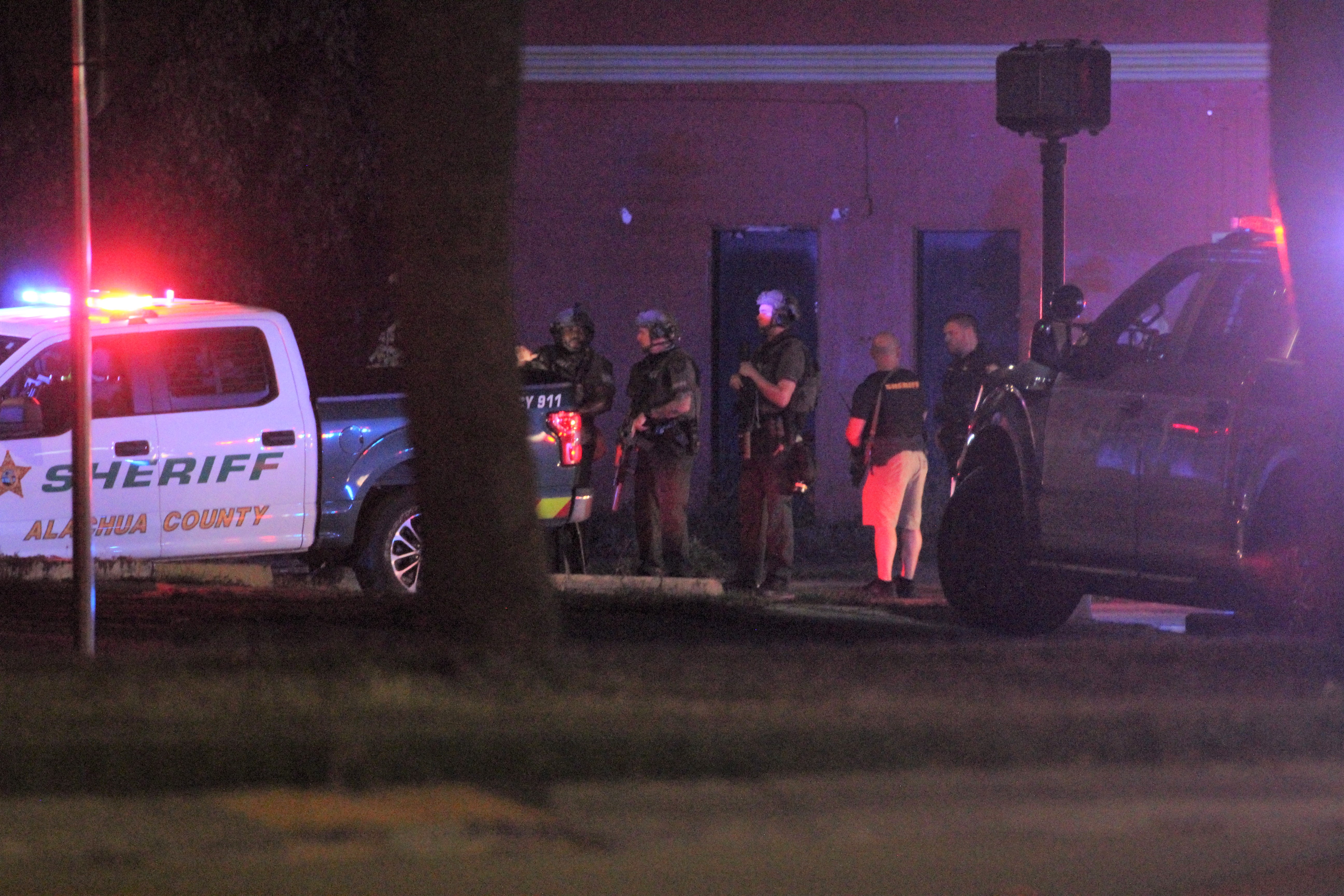 Law enforcement officers at a standoff with an armed suspect