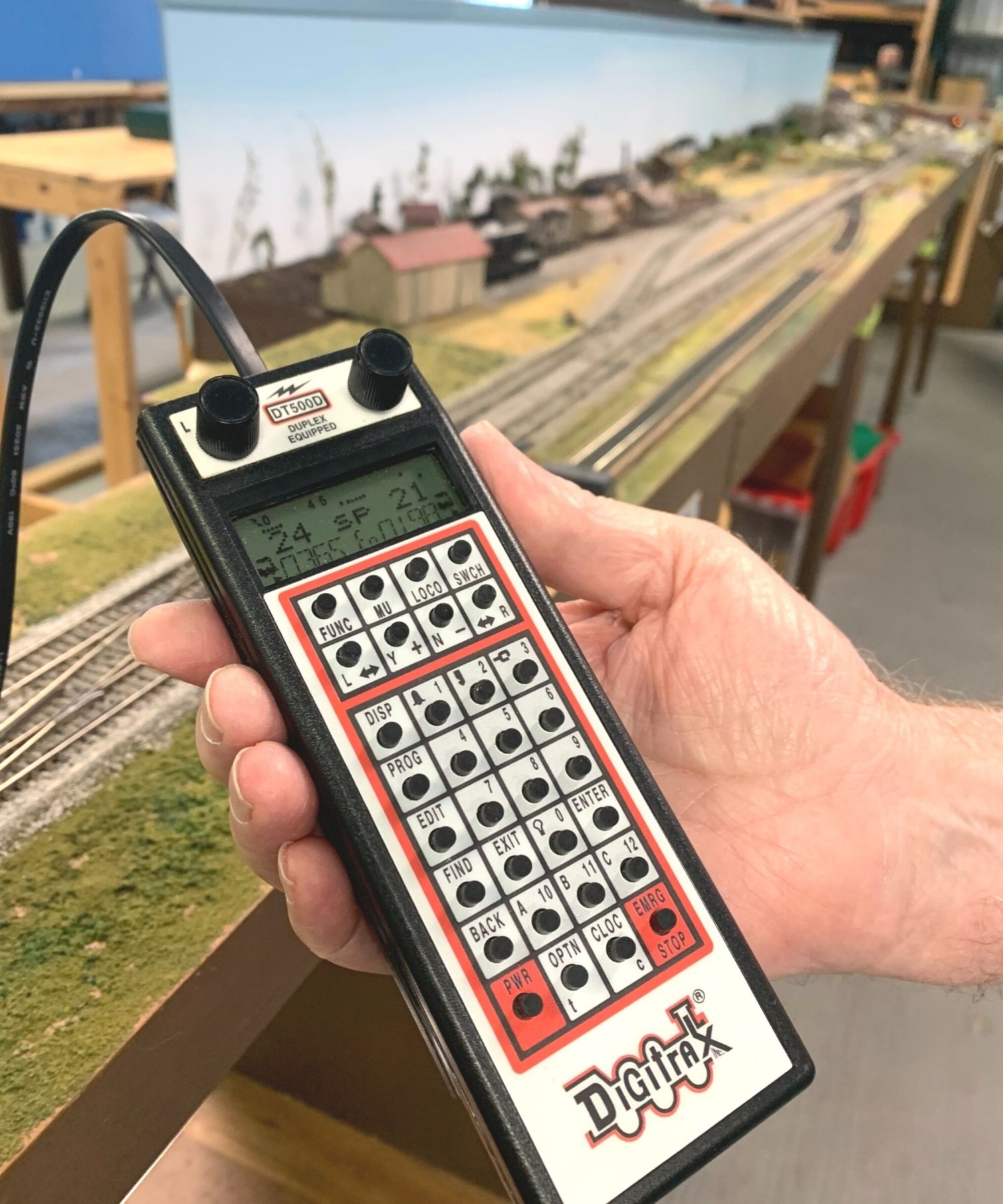 Hand holding model train remote
