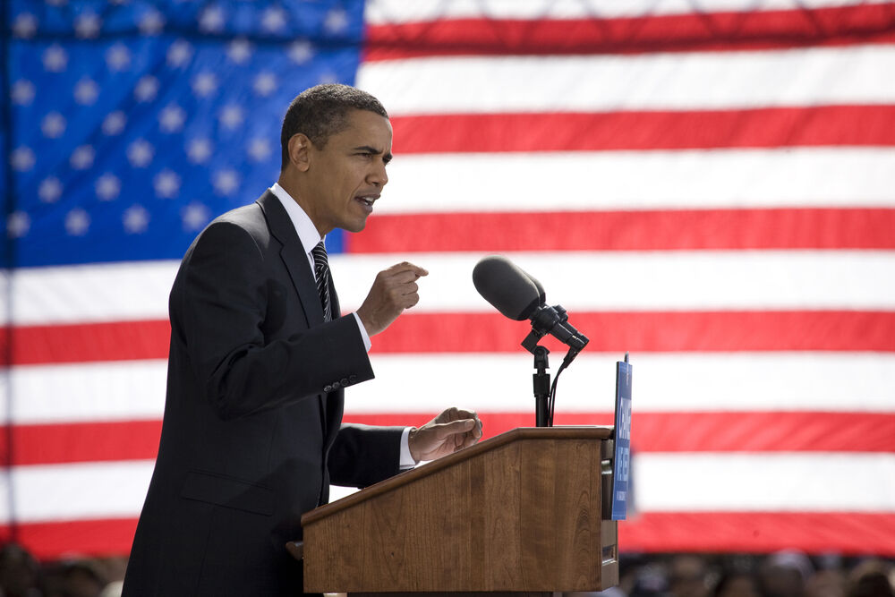 Presidential candidate Barack Obama speaking with American flag in background