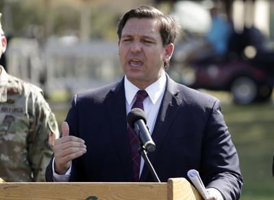 Florida Gov. Ron DeSantis delivers remarks during a news conference at a coronavirus mobile testing site Monday, March 23, 2020, in The Villages, Fla.John RaouxviaAP