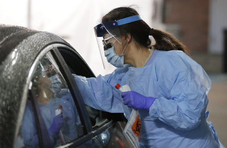 A nurse at a drive-up coronavirus testing station set up by the University of Washington Medical Center on Friday, March 13, 2020.AP Photo/Ted S. Warren William Petri,University of Virginia