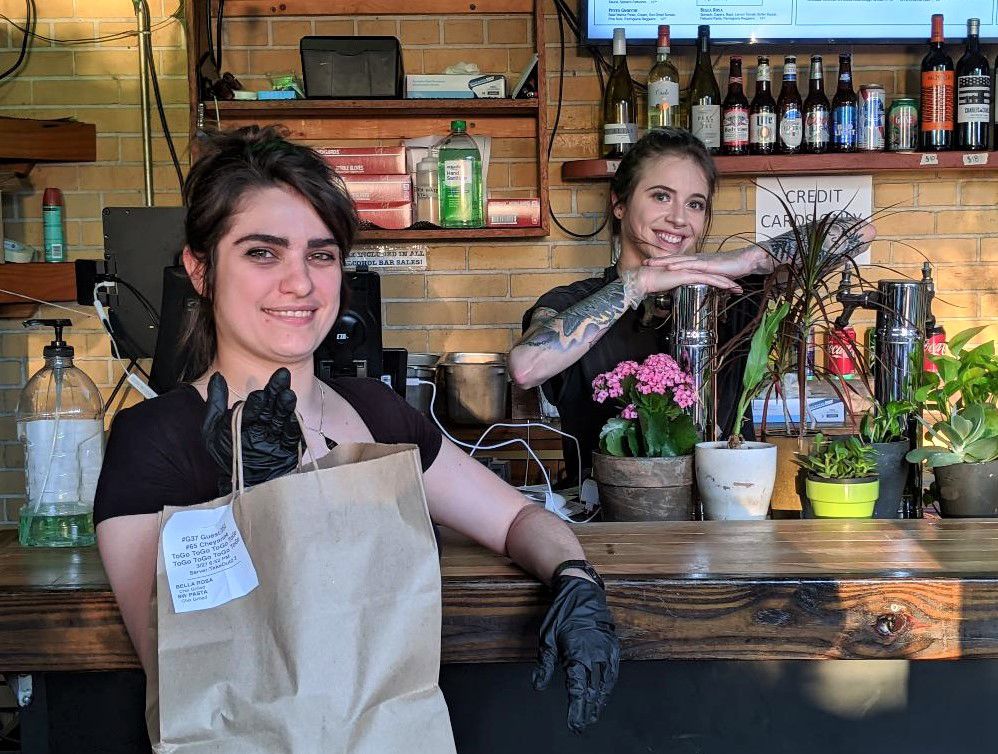 Veronika Kelly, left, and Callie Seip provide customer service on the back patio atthe TOPon Friday night.