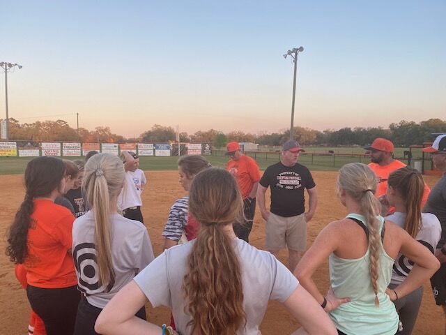 Trenton softball coach Todd Bryant addresses his team following Thursday night's practice.
