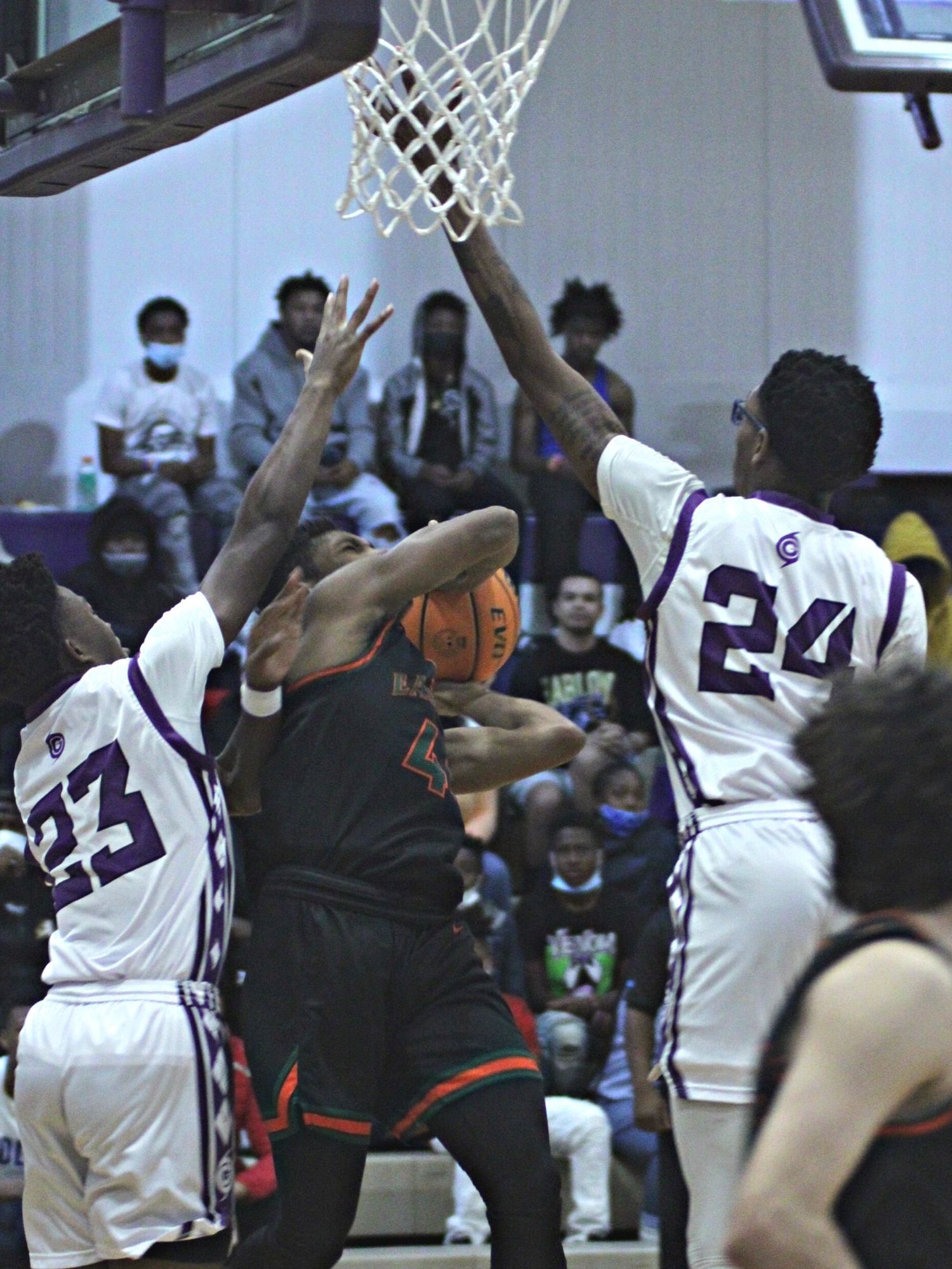 Eastside's Calvin Cooper shoots between Gainesville's Vontrell Hankison (24) and Jordan Bodie (23)