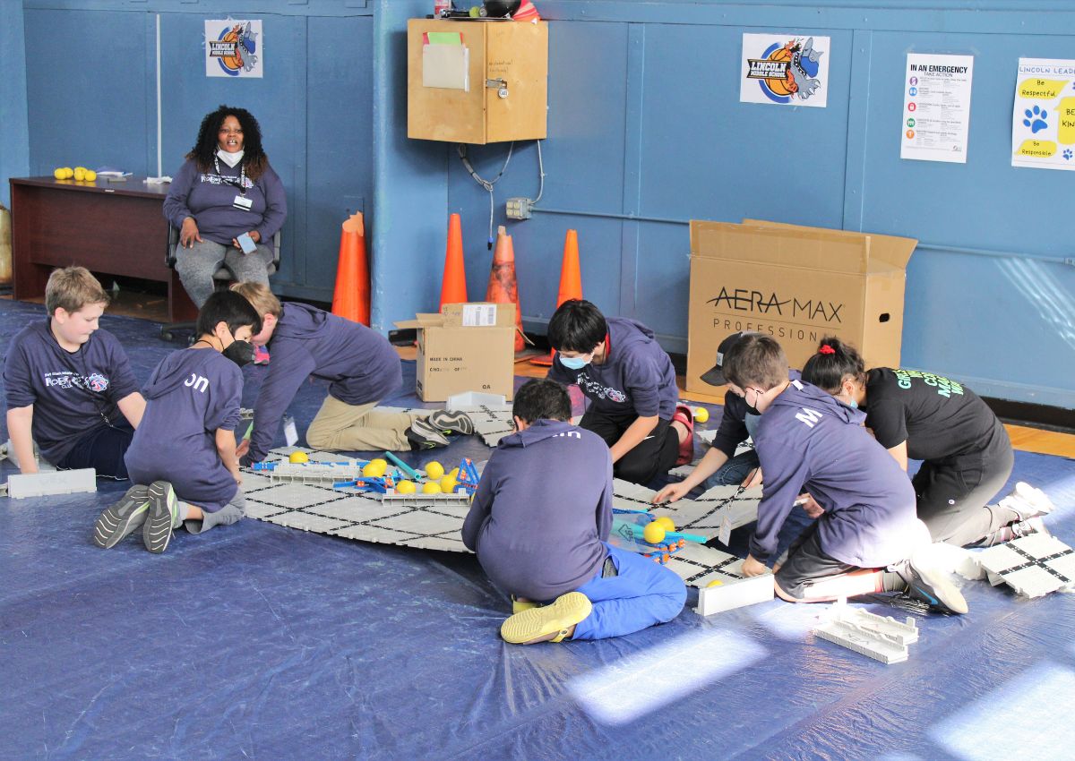 Team from Fort White dissassembles a competition arena