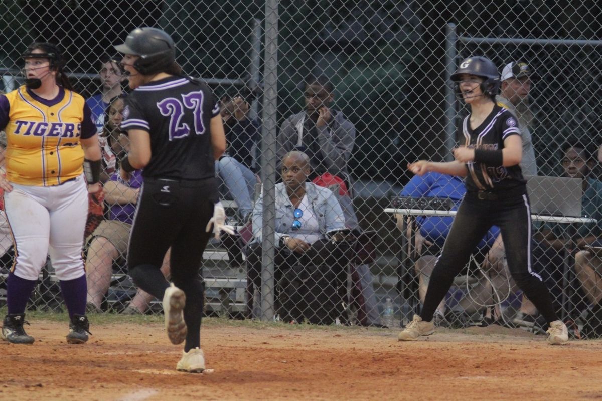 Gainesville's Braylin Cook (27) scores behind Karter Thorp taking 4-3 3rd inning lead