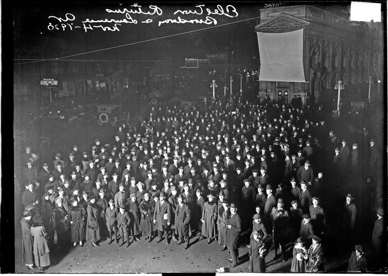 Crowd of people in 1920 watching election