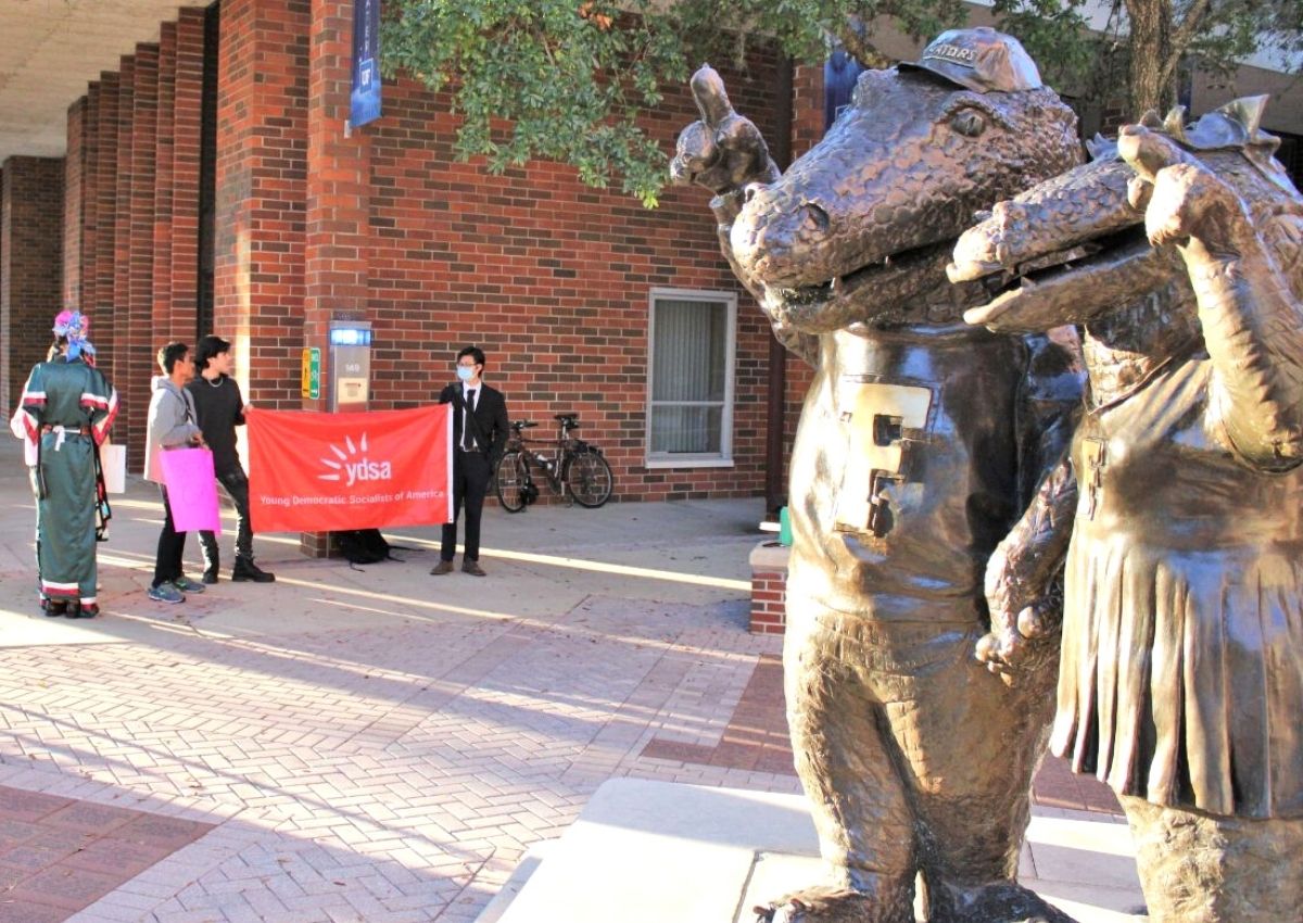 Students hold a Young Democratic Socialists of America banner