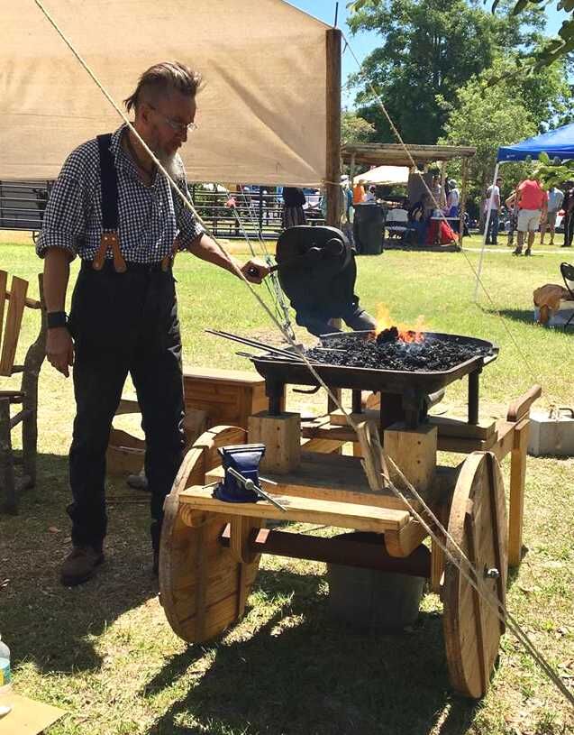 Man heats fire in Heritage Village