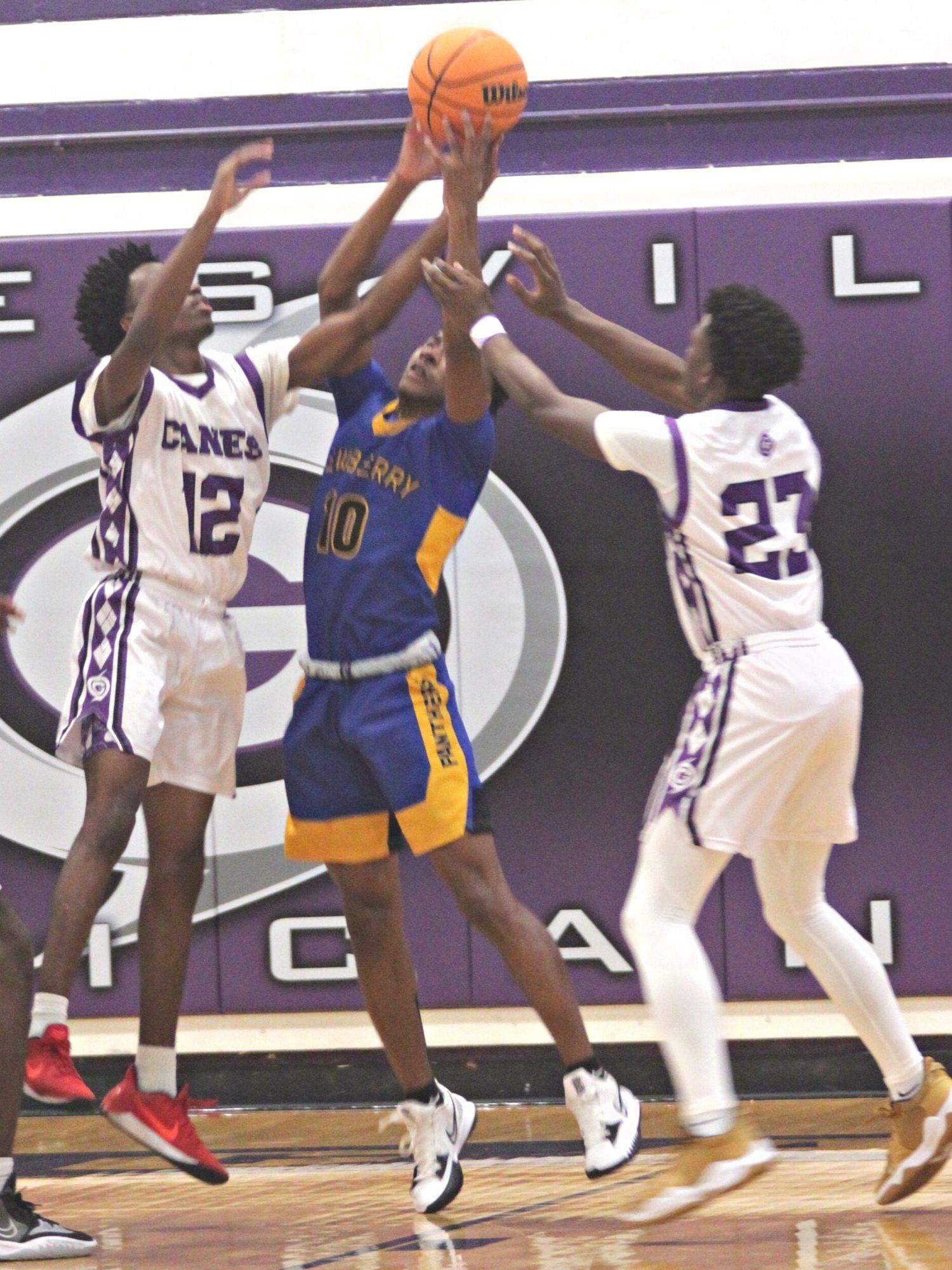 Newberry's Michael Moore goes for rebound between Gainesville's Brendan Bloodworth (12) and Jordan Bodie (23)