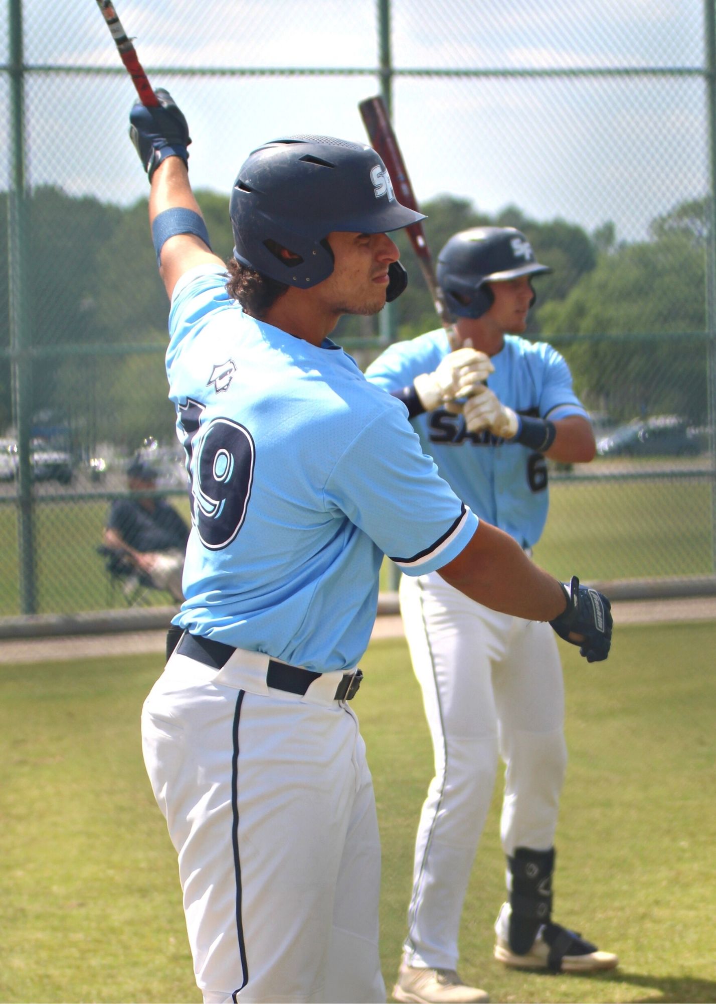 Santa Fe College baseball Gaby Esquivel (19) and Tyler Shelnut (6) warming up