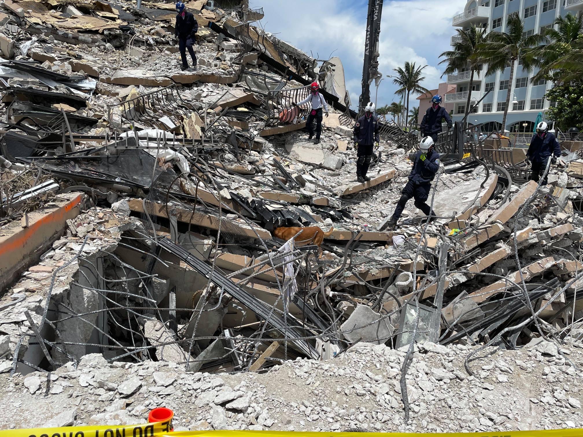 Workers pick through ruins of the condominium collapse in Surfside