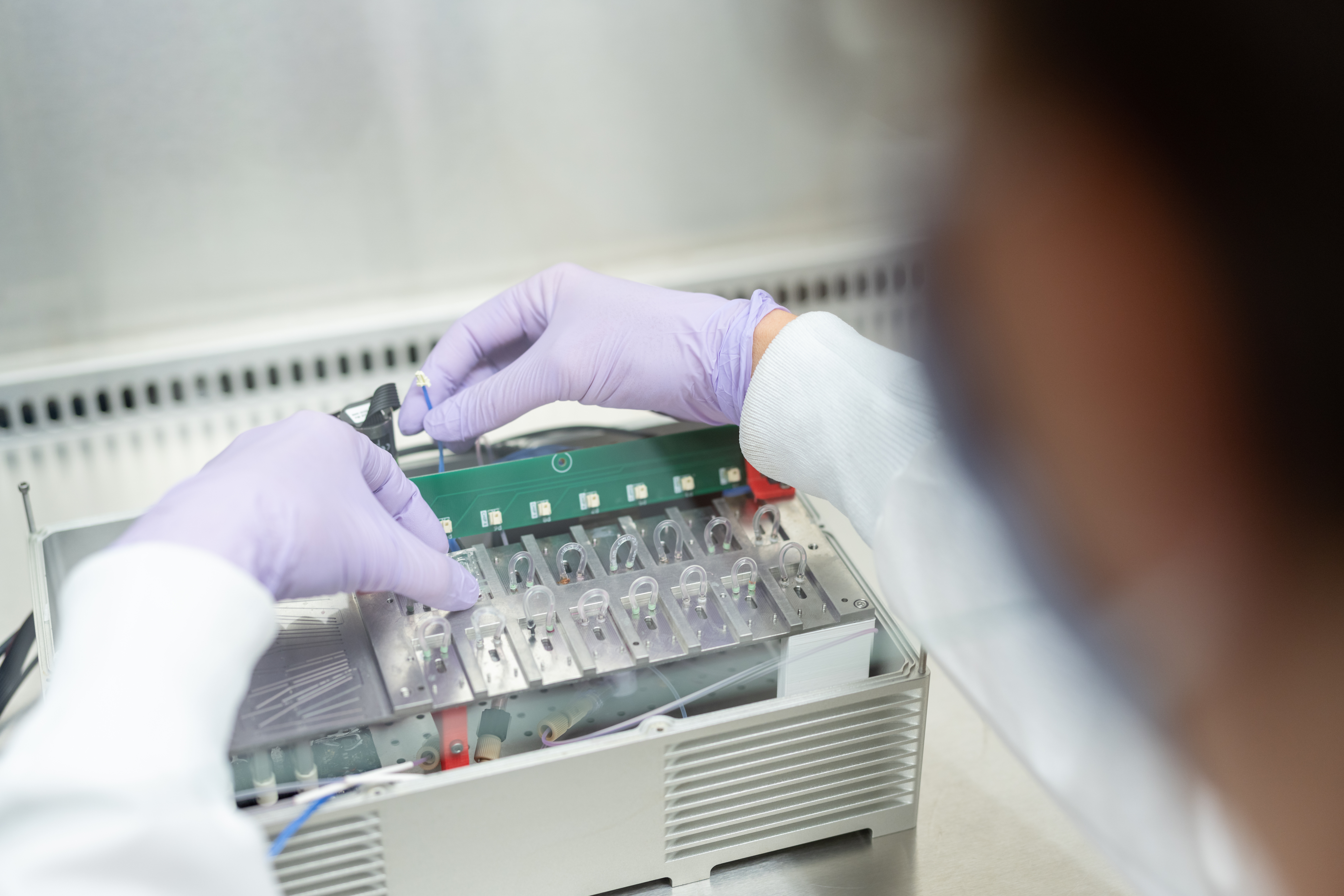 Gloved Scientist Sending Tissue chips