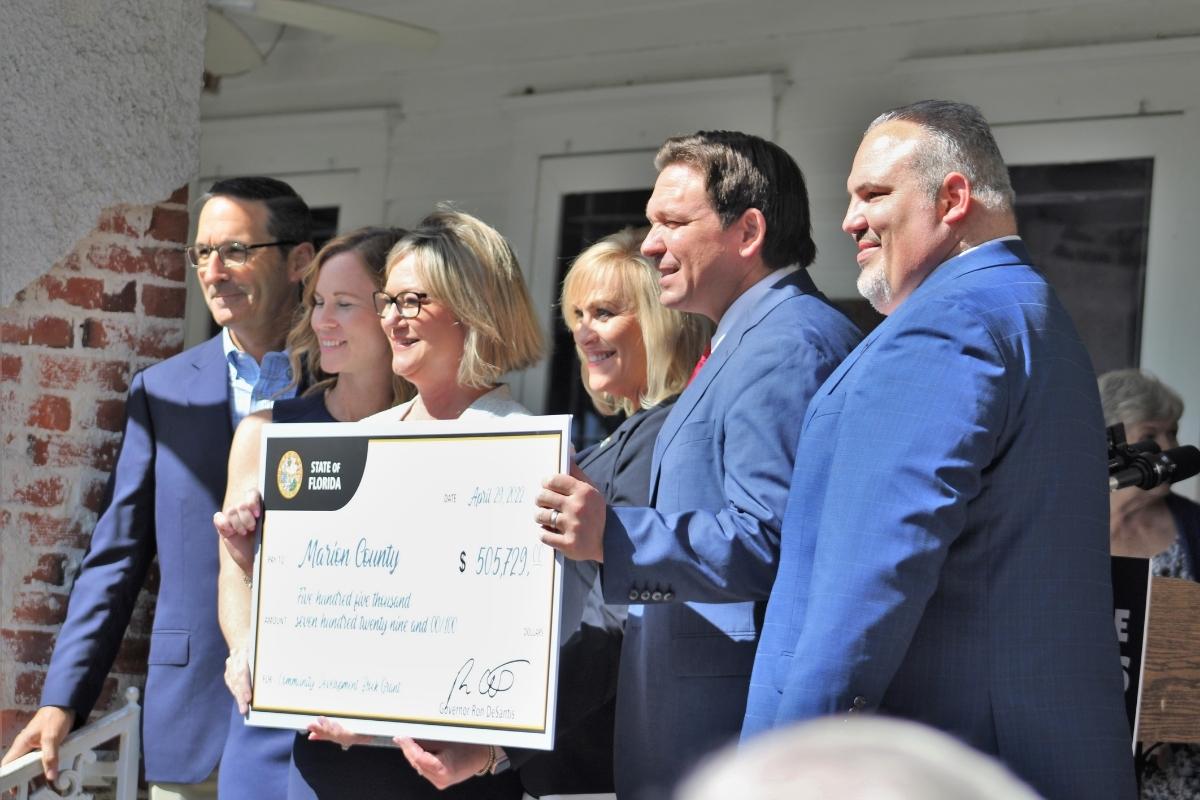 DeSantis hands Marion County officials a check