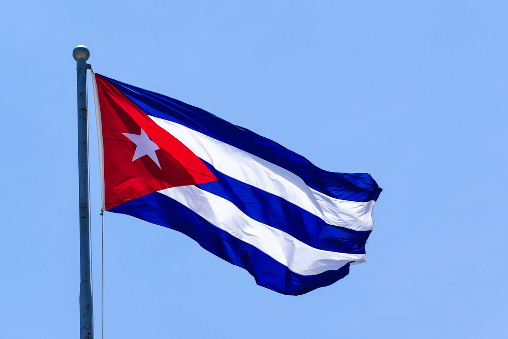 Cuban flag blowing in wind against blue sky background