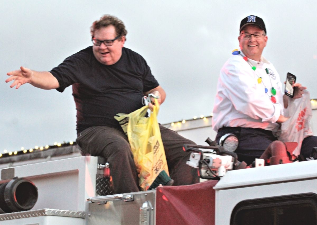 Newberry commissioners Monty Farnsworth and Tim Marden on firetruck at Christmas parade