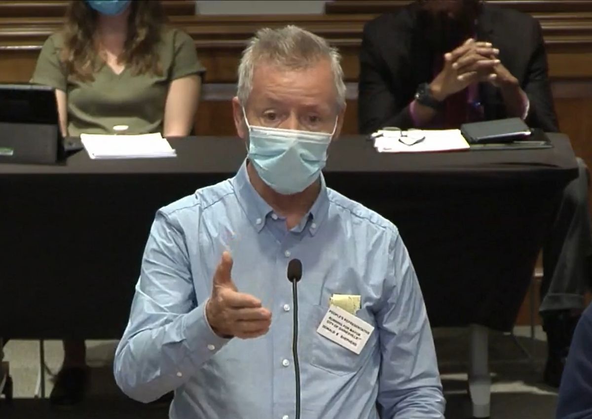 Donald Shepherd speaking behind microphone