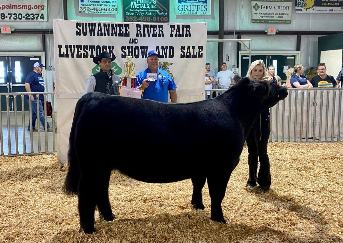 Harleigh Rucker poses with black steer