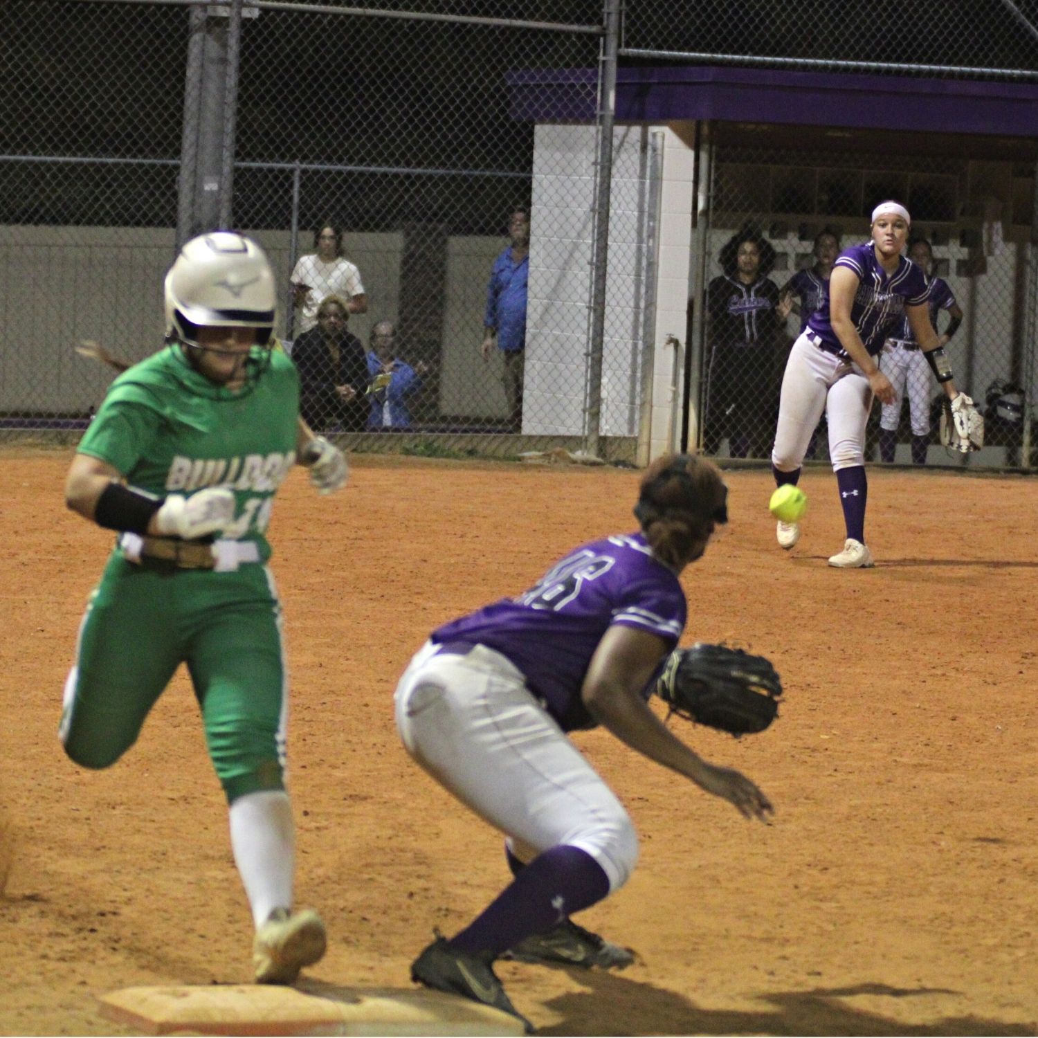 Suwannee's Braylyn Federico safe at 1b beating Gainesville's Braylin Cook throw to 1b Kamron Sumler in 7th inning