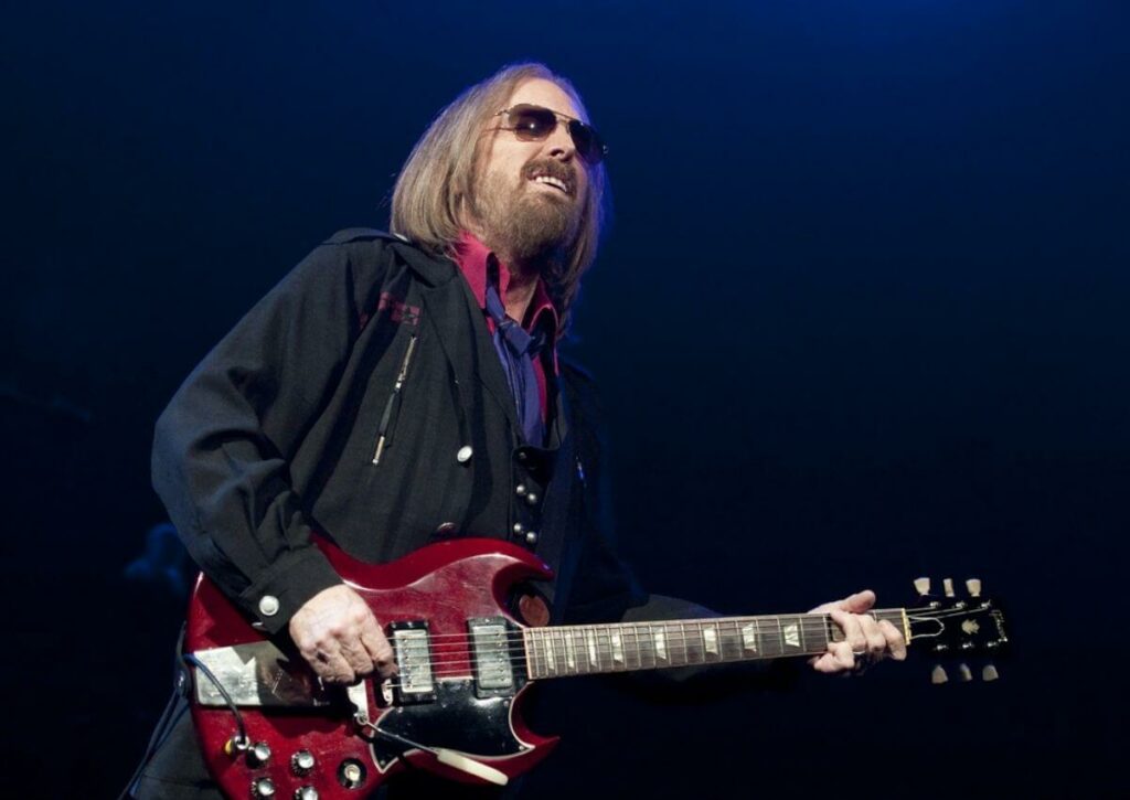 Tom Petty performing on stage.