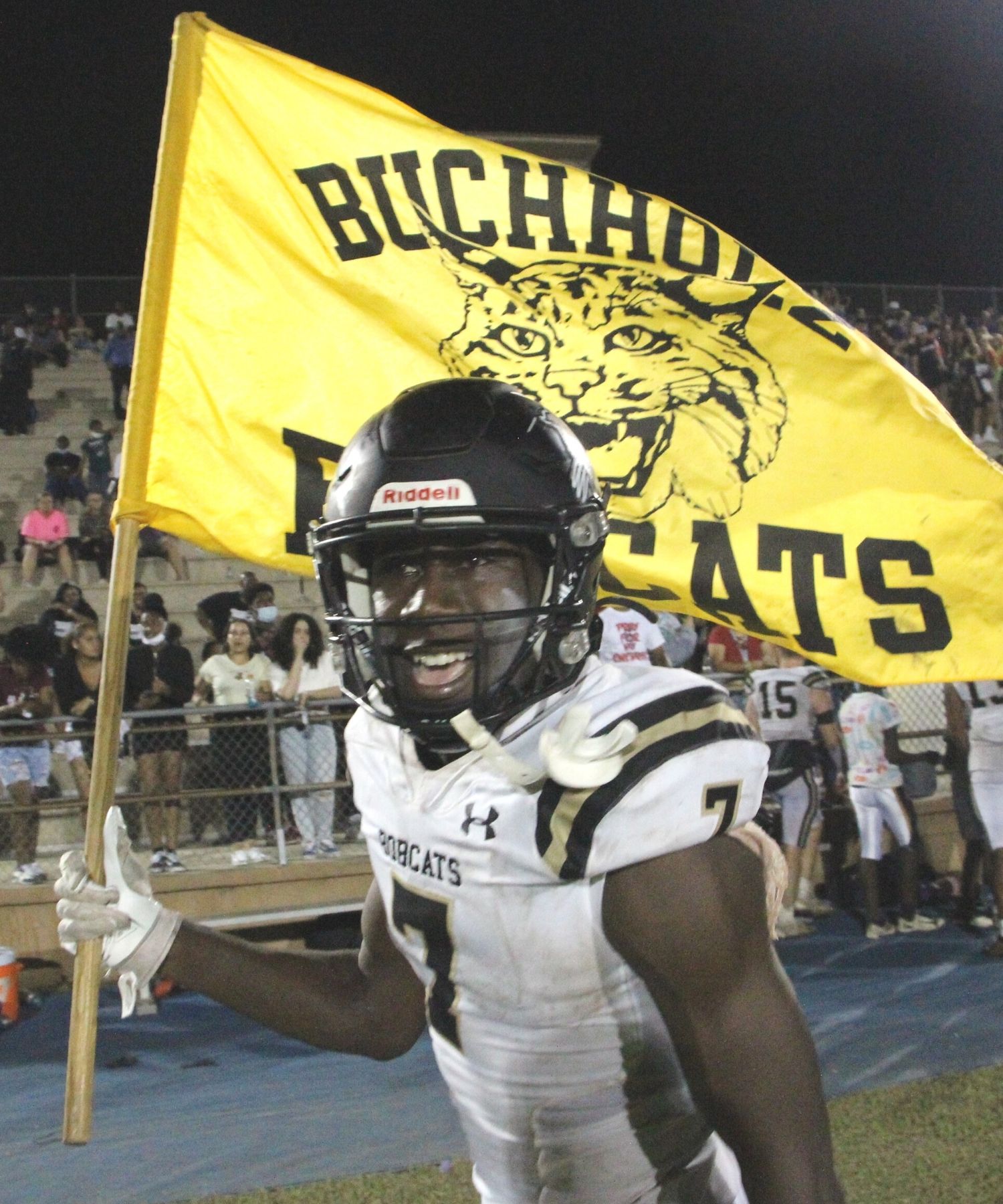 Buchholz WR Quan Lee waves Buchholz school flag